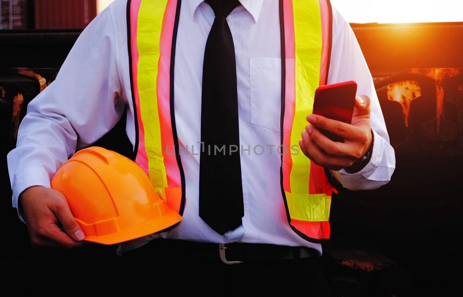 The engineer is working with smart phone with large industry bac by 0864713049