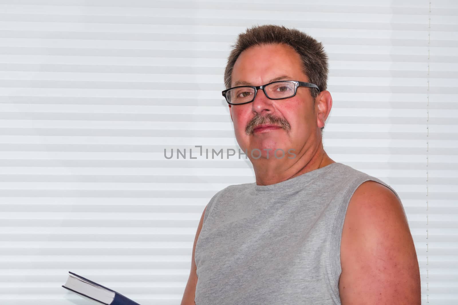  Portrait of a mature businessman on bright background. Happy senior man looking at the camera isolated against white wall with copy space.