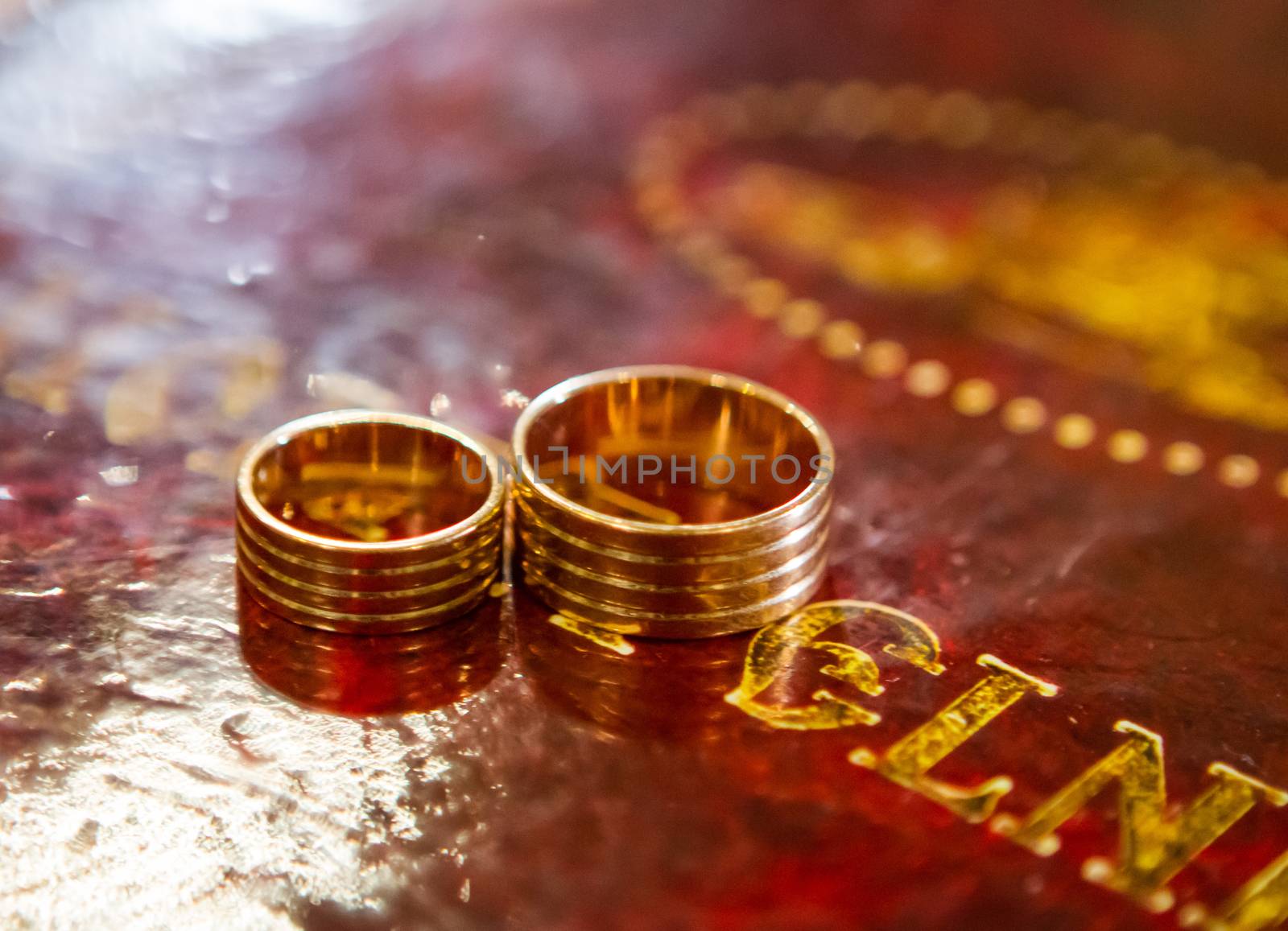 Two wedding rings on bible, on church altar