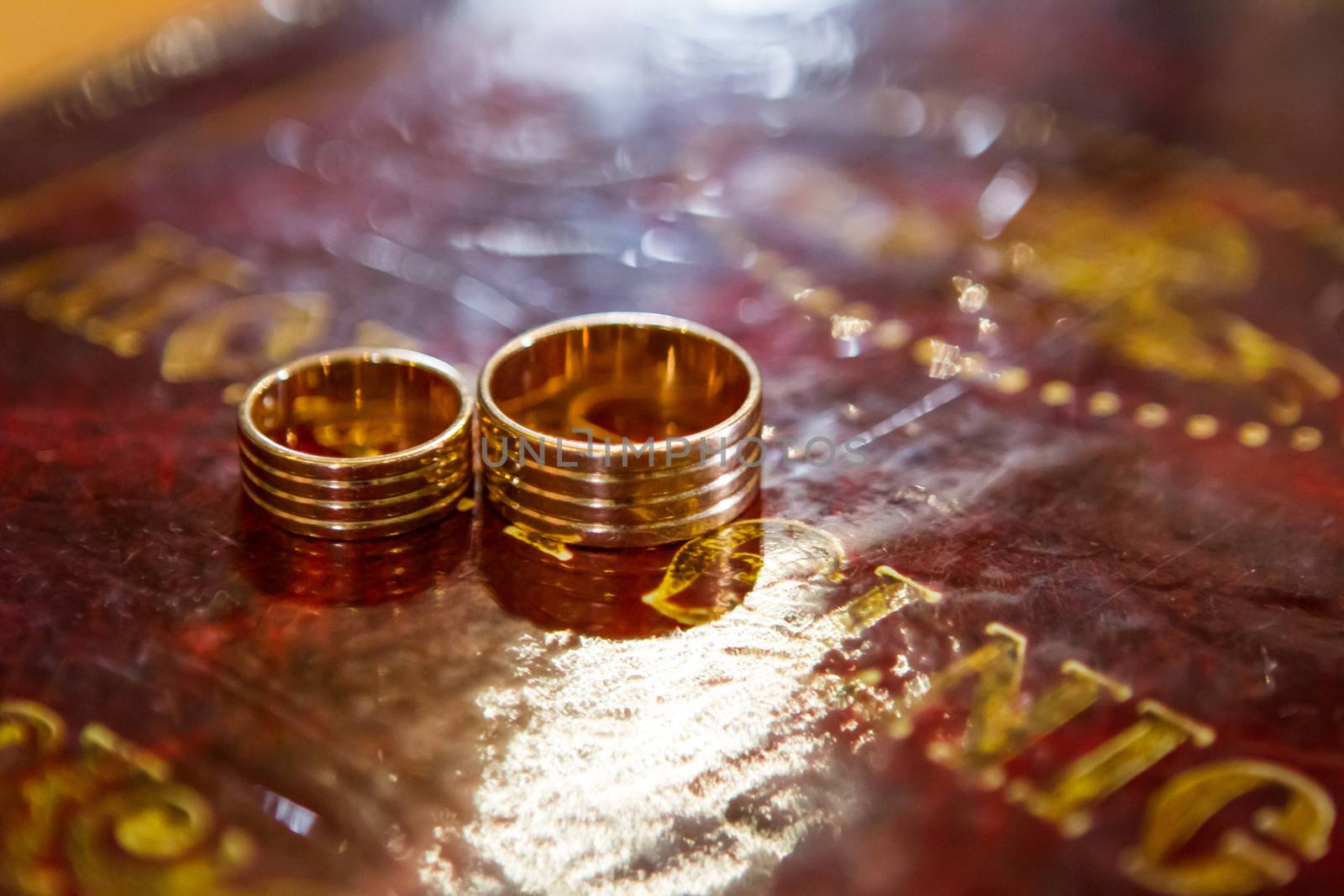 Wedding rings on bible, on church altar by Angel_a