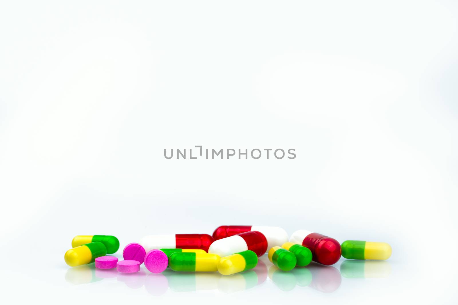 Pile of colorful capsule and tablets pills on white background with copy space for text. Pharmacy department in the hospital concept. Drug store concept. Pharmaceutical industry. Pharmacy background. Global healthcare concept.