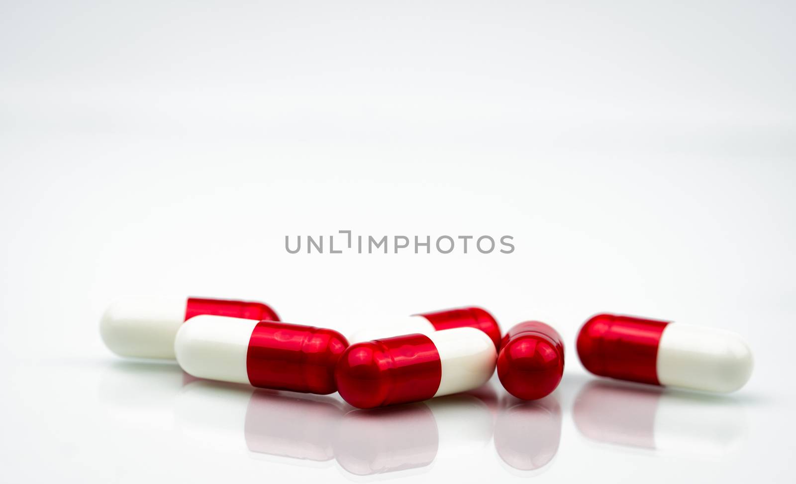 Selective focus of antibiotic capsules pills on white background with copy space. Drug resistance concept. Antibiotics drug use with reasonable and global healthcare concept. Pharmaceutical industry. Pharmacy background.