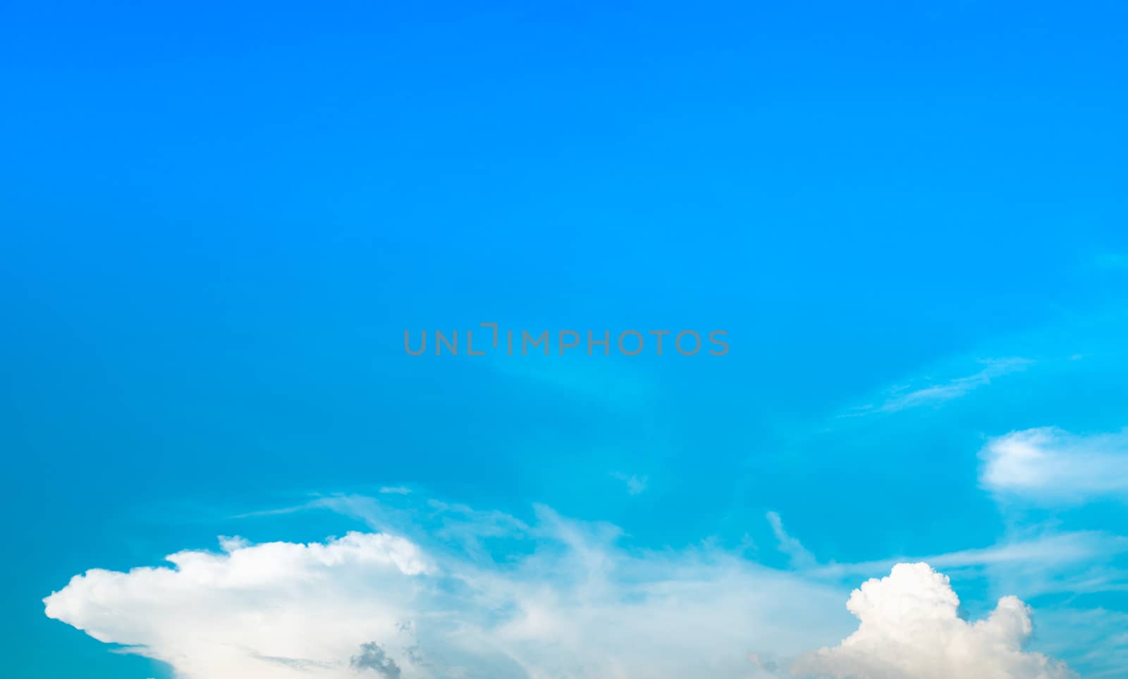 Beautiful blue sky and white cumulus clouds background. Background for peace, summer, bright day. Use for happy mood, fun and vacation day on summer background
