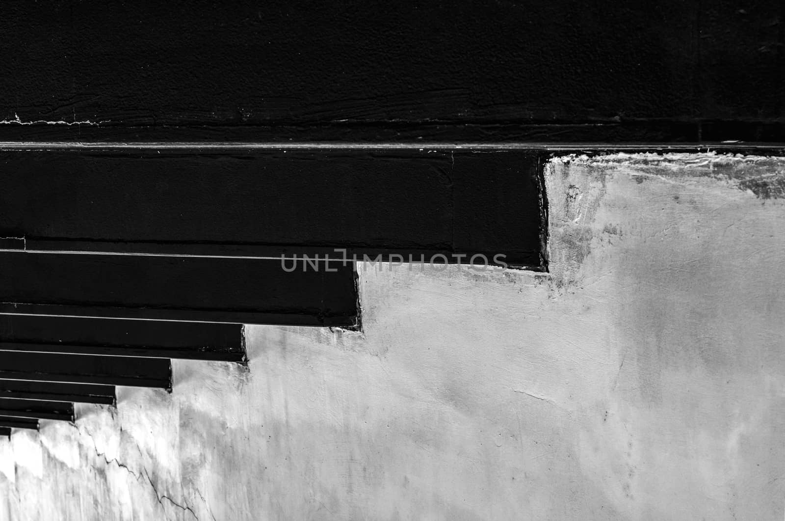 Black and white concrete wall texture background with unique pattern. Step to success strategy. Business success concept. Concrete walls broken at the bottom. Business with weak financial problem. by Fahroni