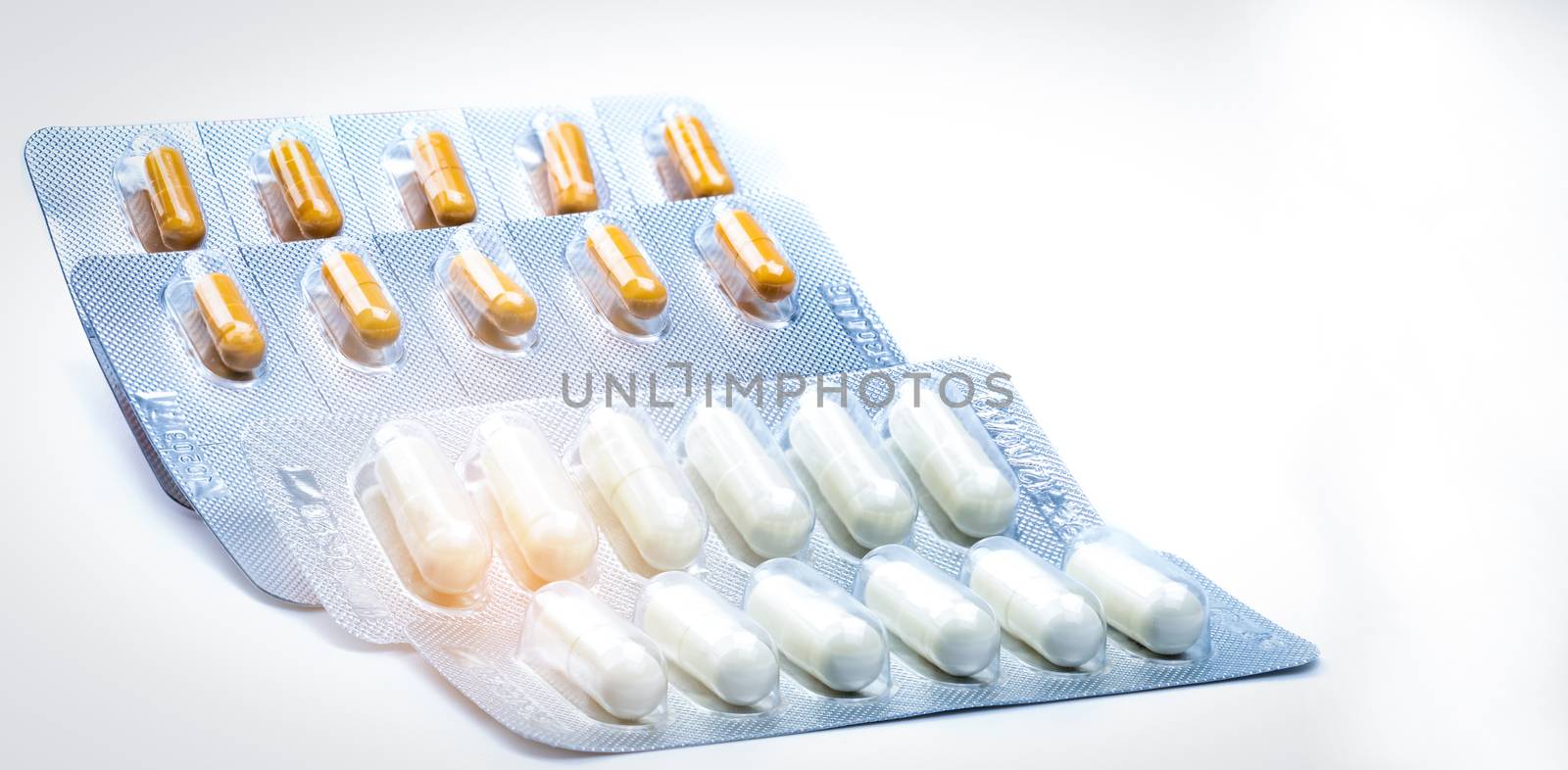 Cefixime and azithromycin capsule in blister pack for treatment gonorrhea. Neisseria Gonorrhoeae treatment. Antibiotic drug resistance. Orange and white pill. Sexually Transmitted Diseases concept. Pharmaceutical industry. Pharmacy background.