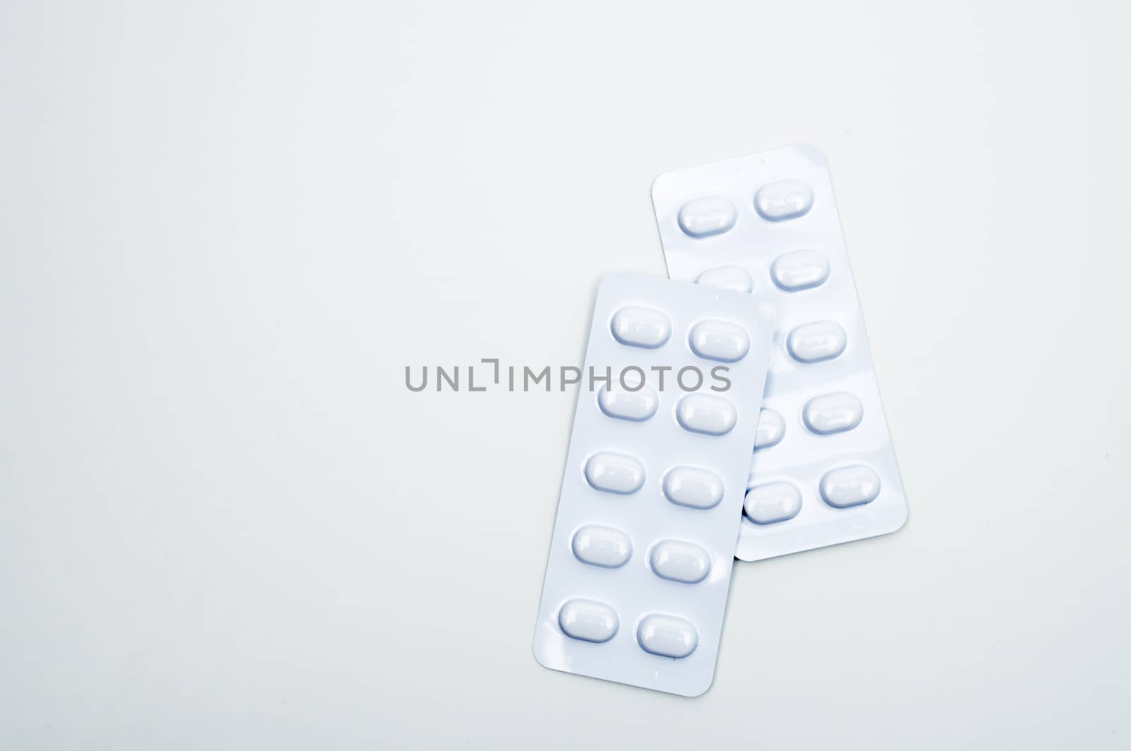 Tablets pill in white blister pack for light resistance packaging isolated on white background. Medicine for treatment NCDs. Elderly people disease. Pharmaceutical industry. Pharmacy background. Global healthcare concept.