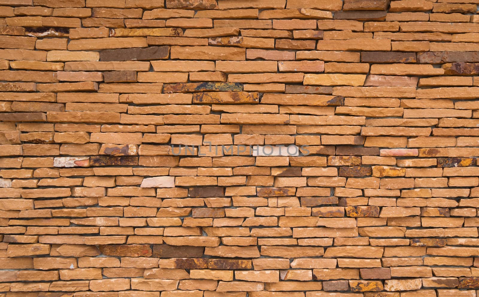 Orange brick wall texture background with space for text by Fahroni