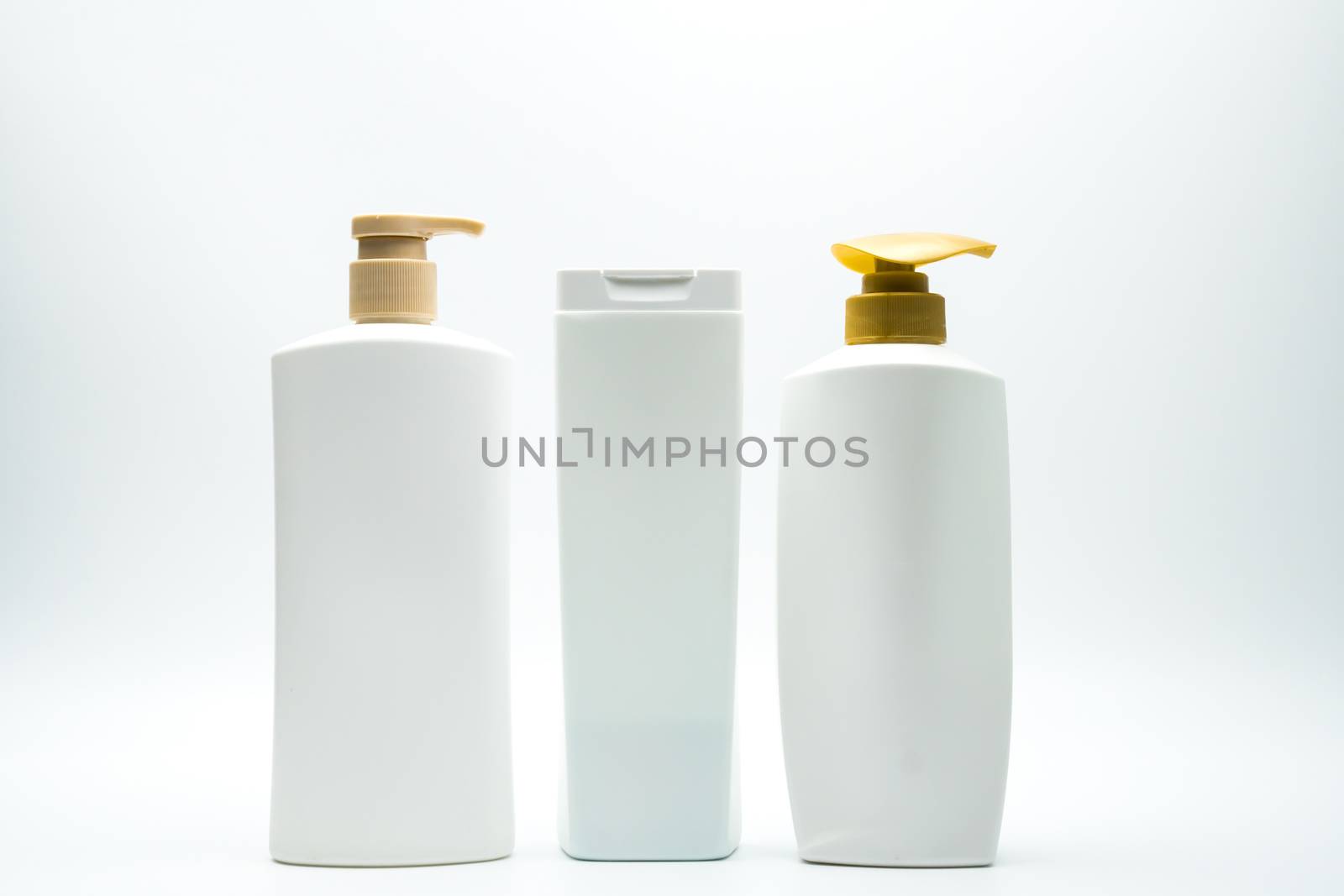 Set of shampoo and hair conditioner plastic bottle with golden pump isolated on white background with blank label and copy space