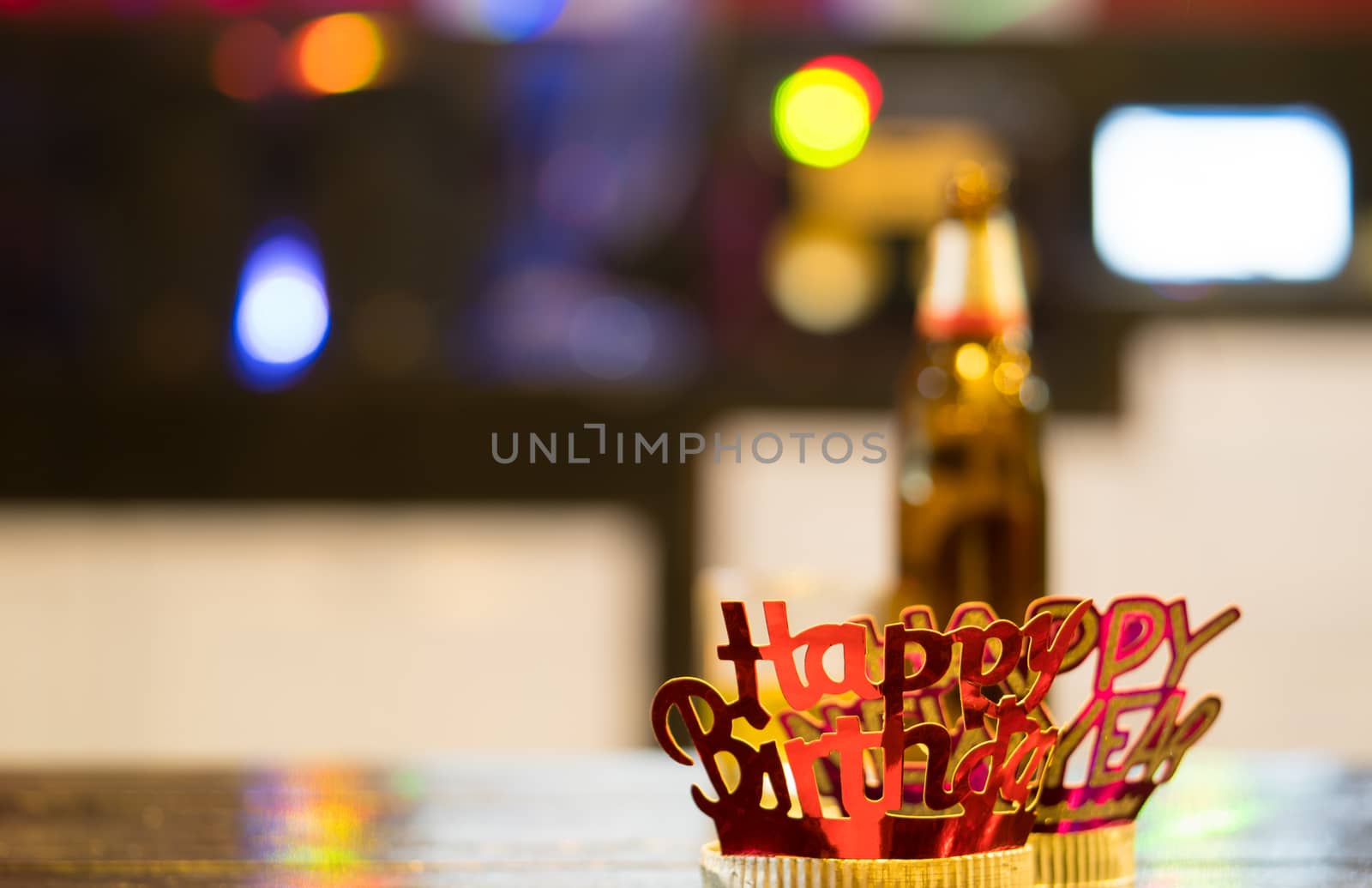 Red-golden Happy New Year headband on colorful bokeh background