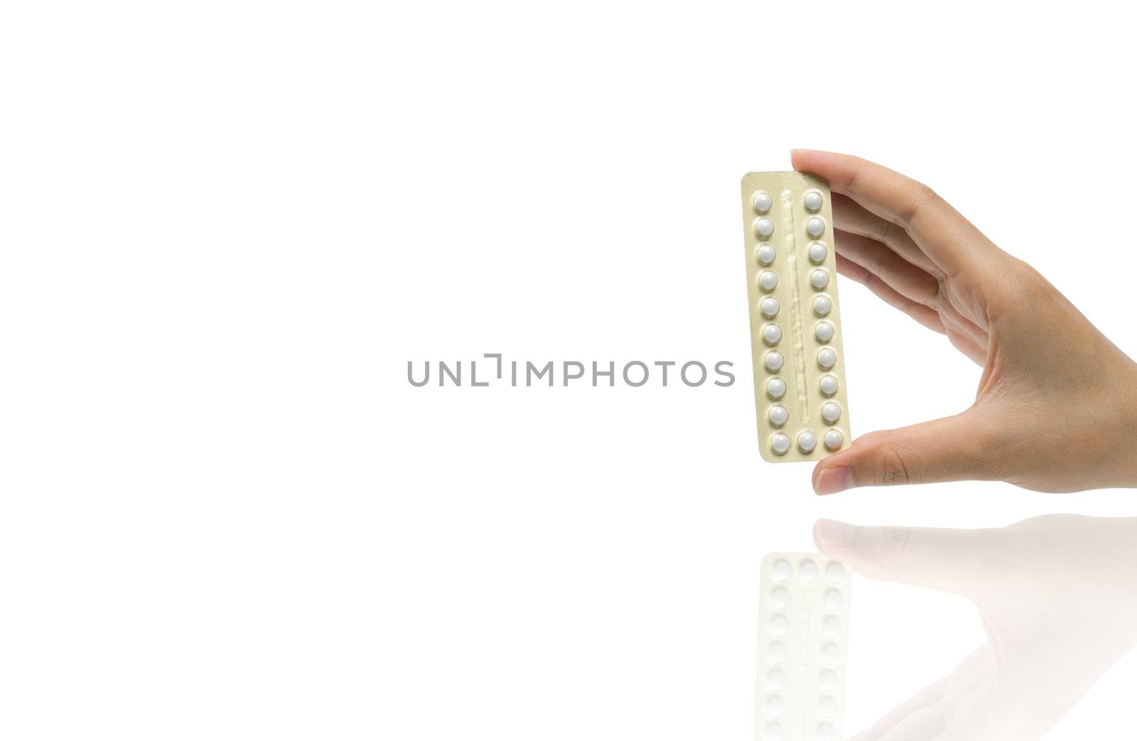 Asian adult woman hand holding pack of contraceptive pills isolated on white background with clipping path. Choosing family planning with birth control pills concept by Fahroni