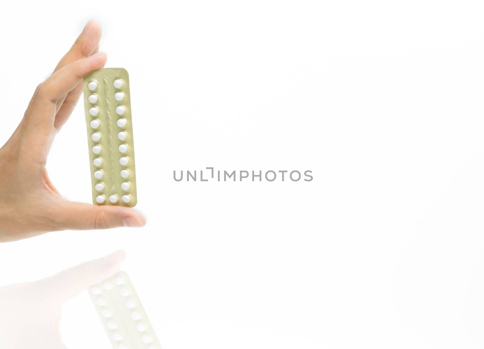 Woman hand taking birth control pills. Asian adult woman holding pack of contraceptive pills isolated on white background with clipping path. Choosing family planning with birth control pills concept by Fahroni