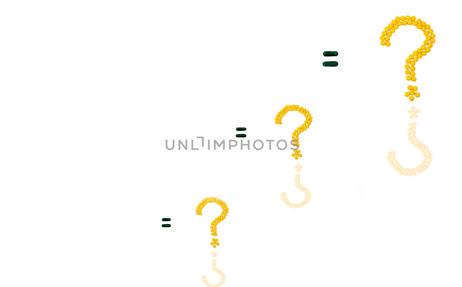 Three questions mark made of yellow sugar coated tablet pills. Equal sign made of capsule pills isolated on white background with copy space