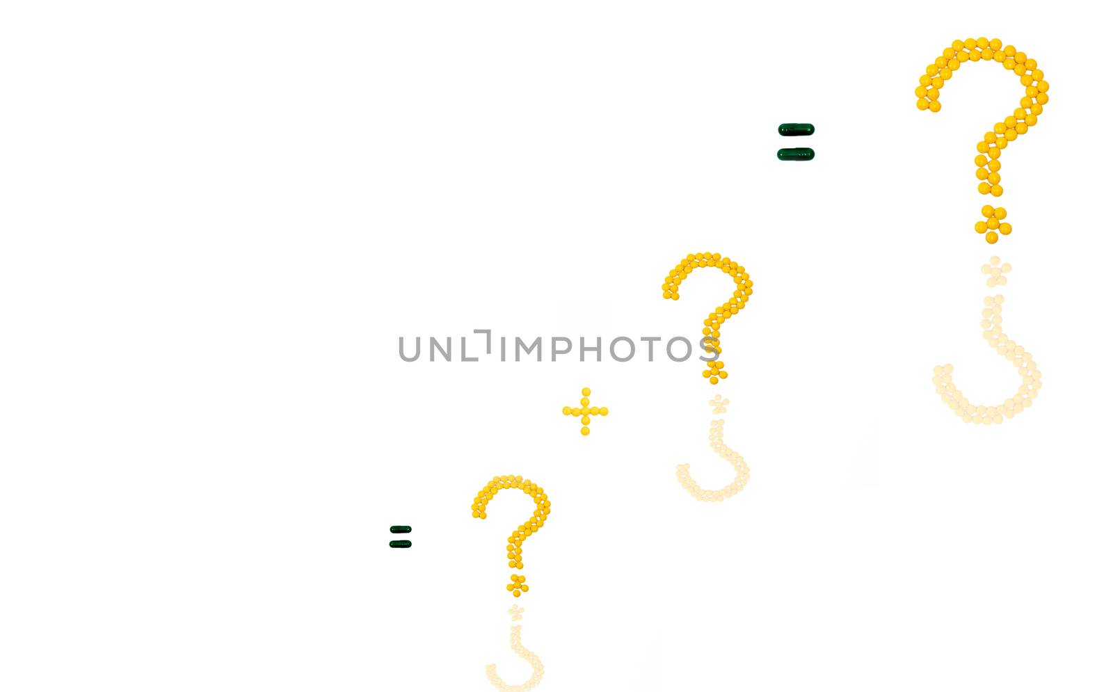 Three question mark and plus sign made of yellow sugar coated tablet pills. Equal sign made of capsule pills isolated on white background.