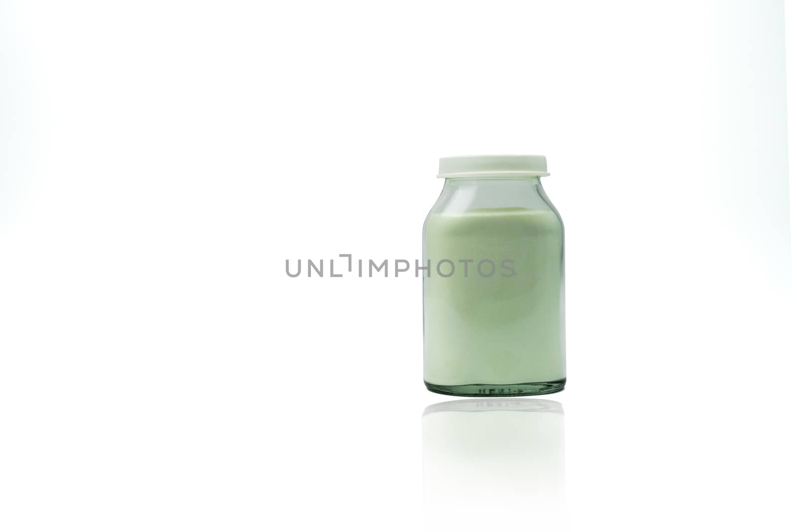 Green lemon flavored effervescent powders in transparent glass bottle with blank label and copy space isolated on white background. Pharmaceutical packaging industry. by Fahroni