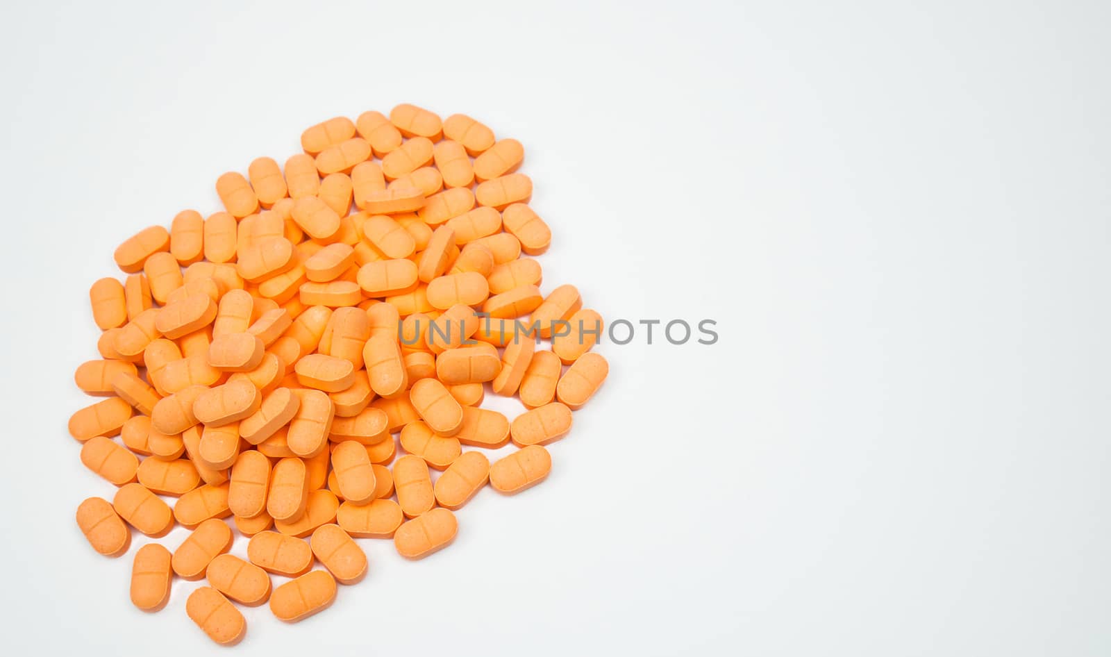 Pile of muscle relaxant, pain relief tablet pills isolated on white background with copy space for text. Pharmaceutical industry production. Pharmacy background. Orange tablets pill. by Fahroni