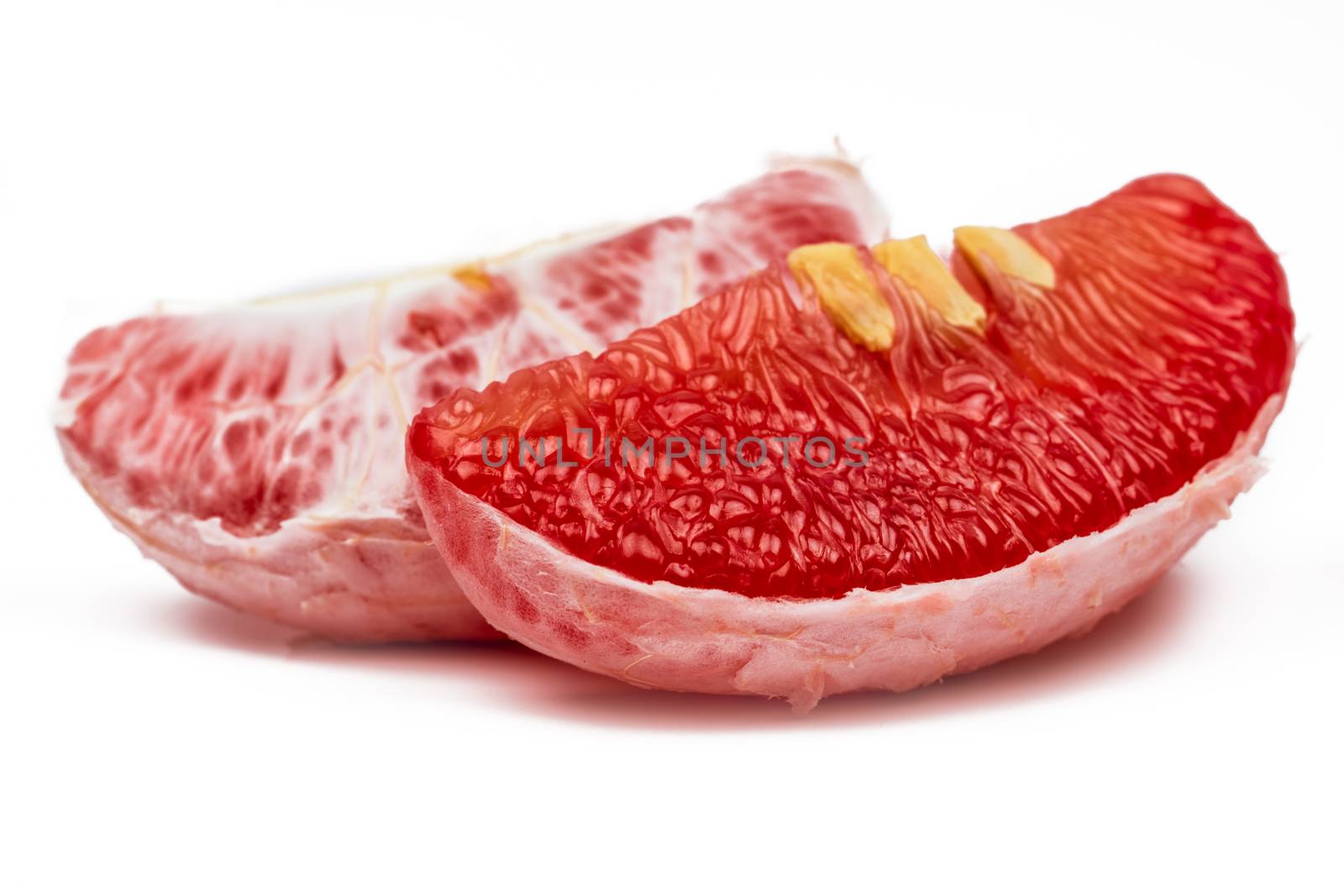 Red pomelo pulp with seeds isolated on white background. Thailand Siam ruby pomelo fruit. Natural source of vitamin C (antioxidants) and potassium. Healthy food for slow down aging