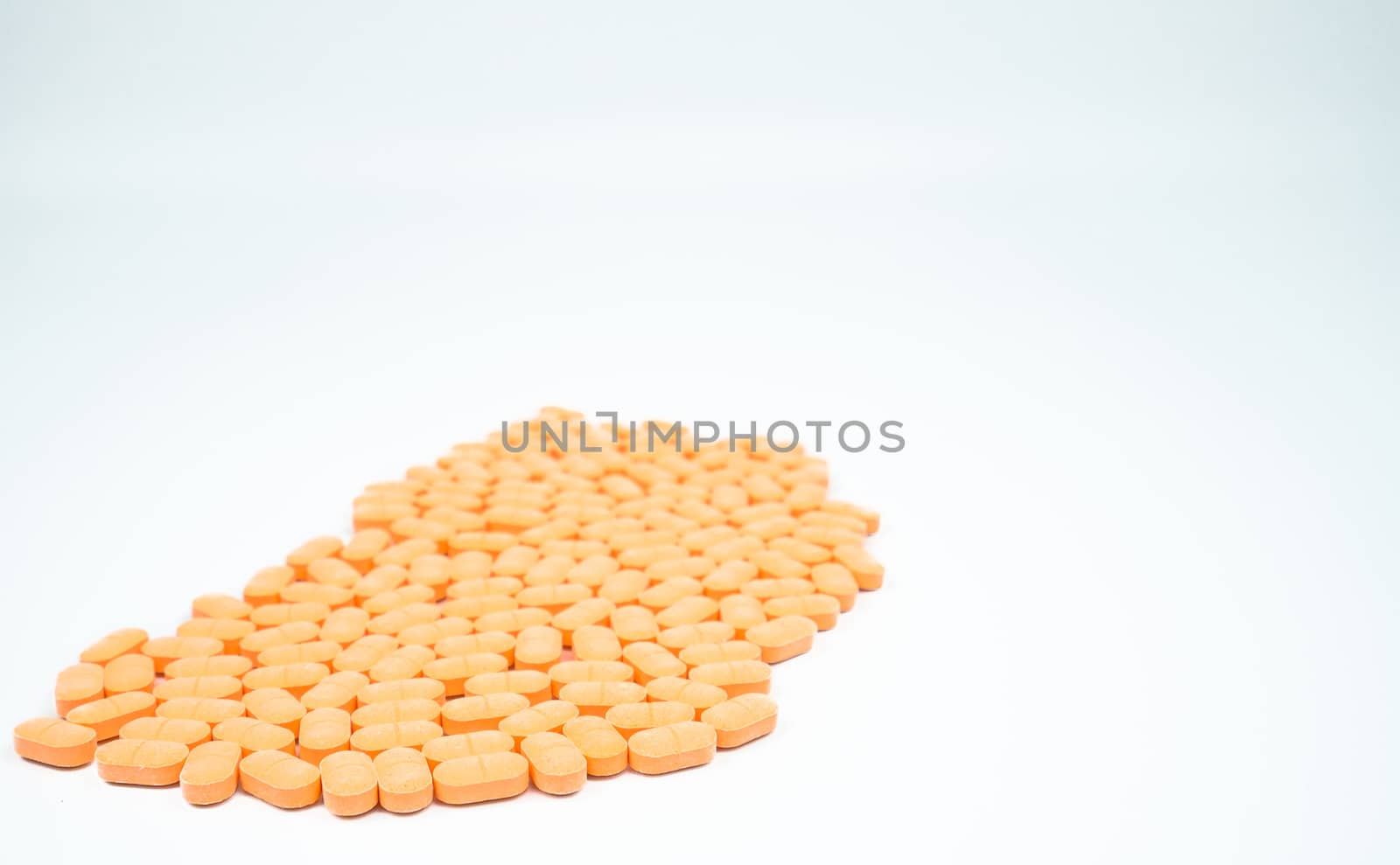 Pile of muscle relaxant, pain relief tablet pills isolated on white background with copy space for text. Pharmaceutical industry. Pharmacy background. Global healthcare concept. by Fahroni