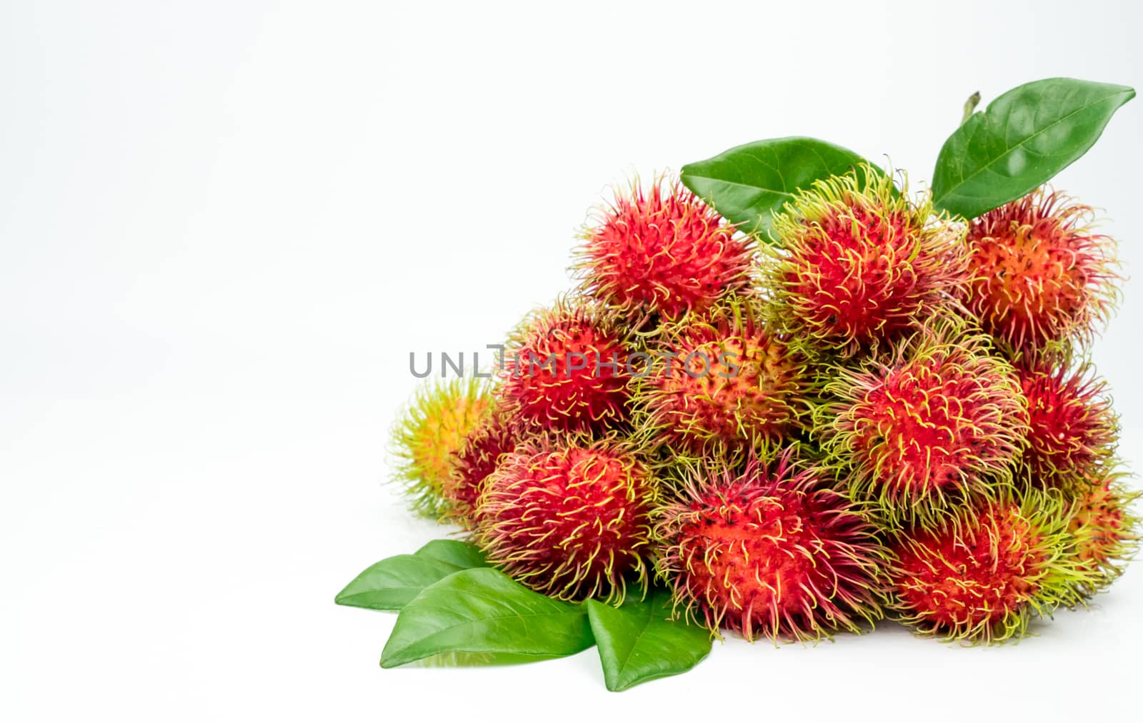 Fresh red ripe rambutan (Nephelium lappaceum) with leaves isolated on white background. Thai dessert sweet fruits. by Fahroni