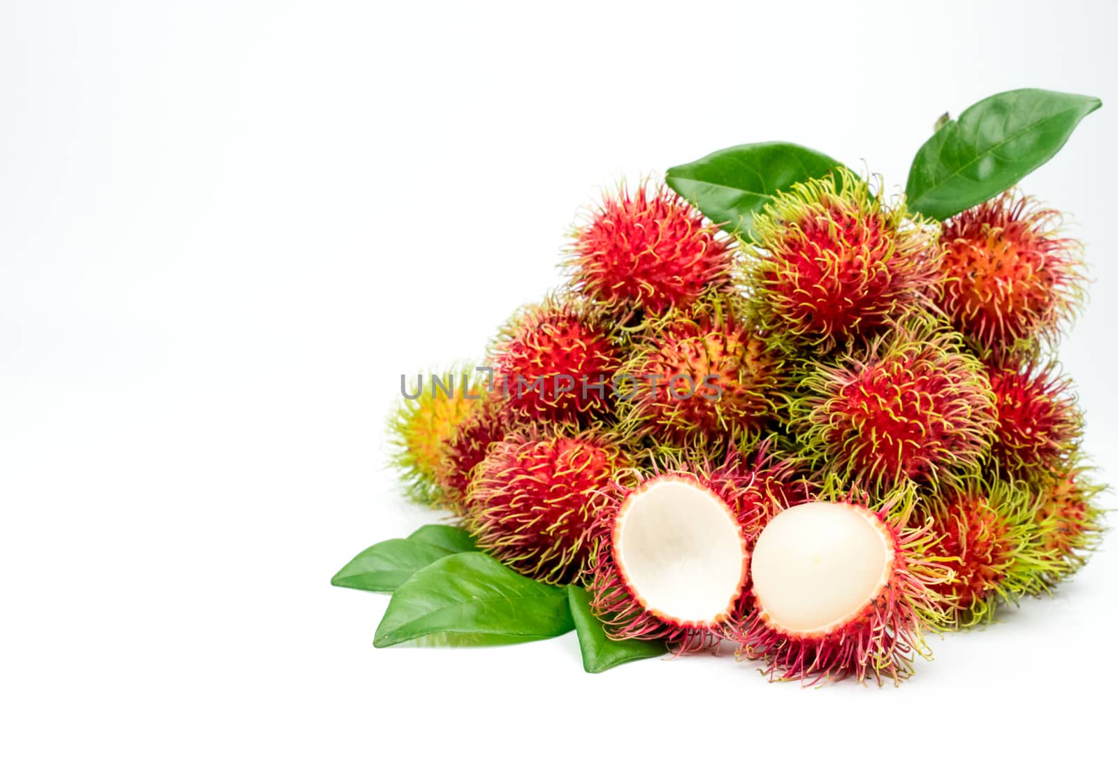 Closeup of fresh red ripe rambutan (Nephelium lappaceum) with leaves isolated on white background. Thai dessert sweet fruits. Tropical fruit. by Fahroni