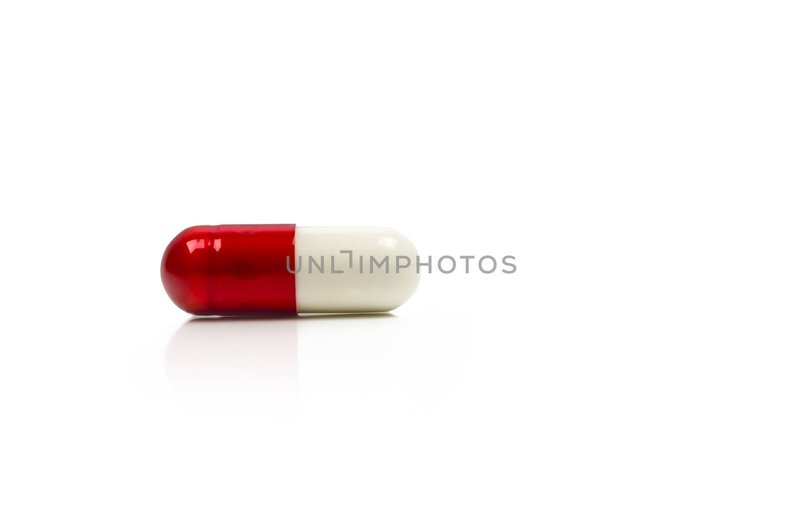 Red, white antibiotics capsule pill isolated on white background with copy space. Drug resistance concept. Antibiotics drug use with reasonable and global healthcare concept. Pharmaceutical industry. Pharmacy background.