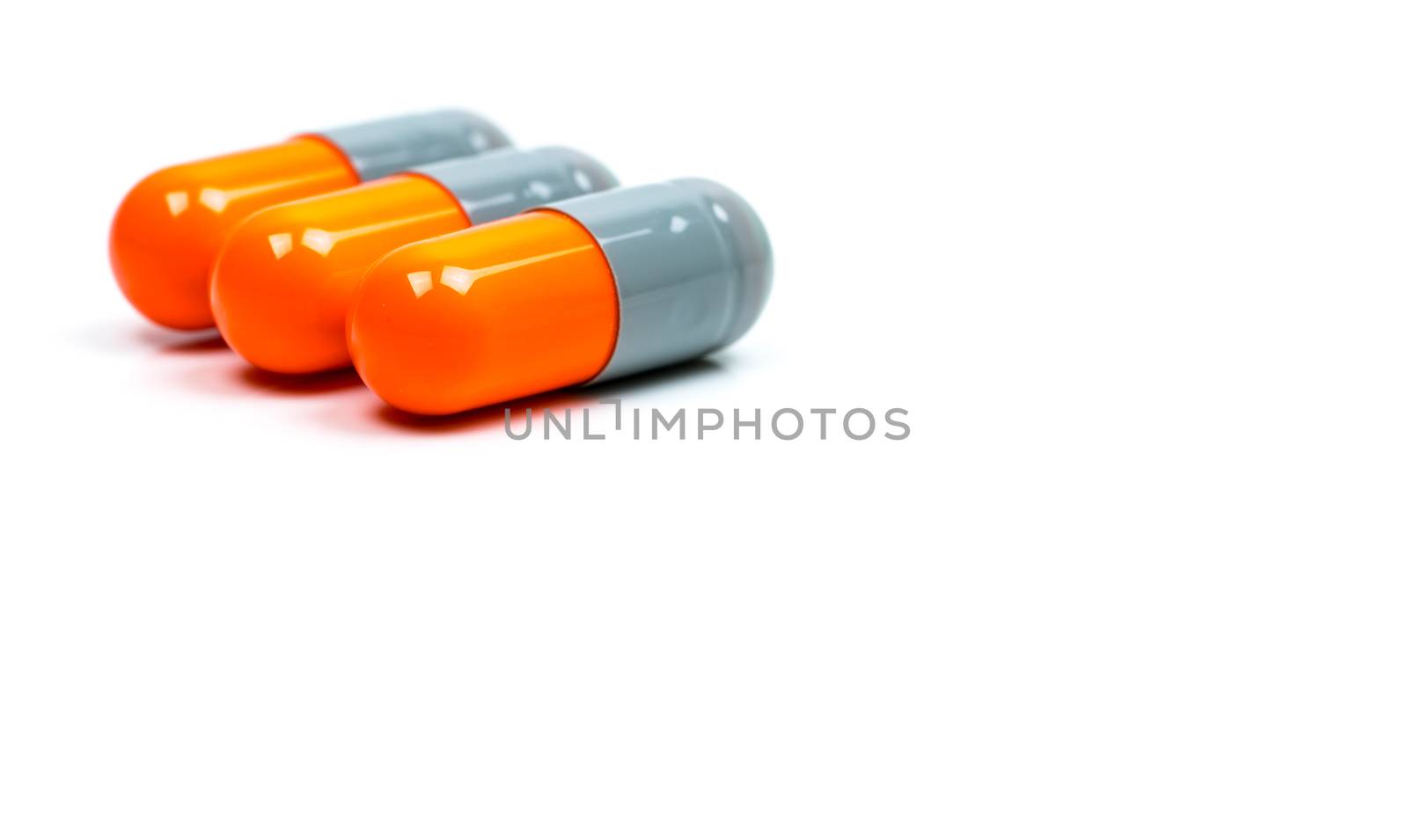 Selective focus of antibiotic capsules pills on blur background with copy space. Drug resistance concept. Antibiotics drug use with reasonable and global healthcare concept. Pharmaceutical industry. Pharmacy background. by Fahroni