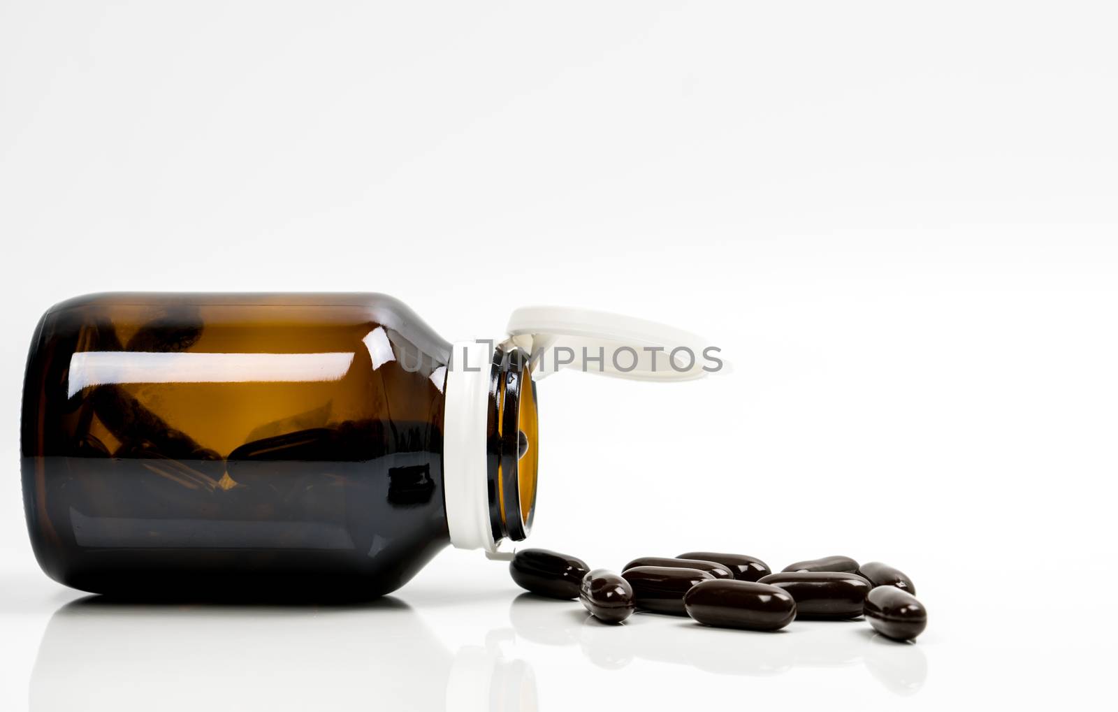 Multivitamins capsule pills for pregnant woman with amber bottle with blank label and copy space isolated on white background. Vitamins and supplements for hard working guy. Global healthcare concept