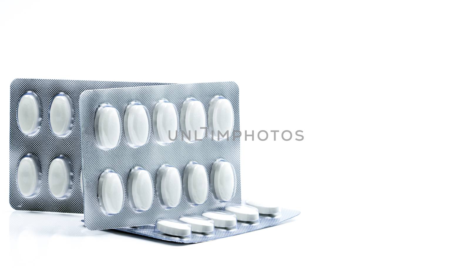 Vitamins and supplements tablets in blister pack on white background. Antioxidants for healthy skin. Good supplement pills for woman bone.