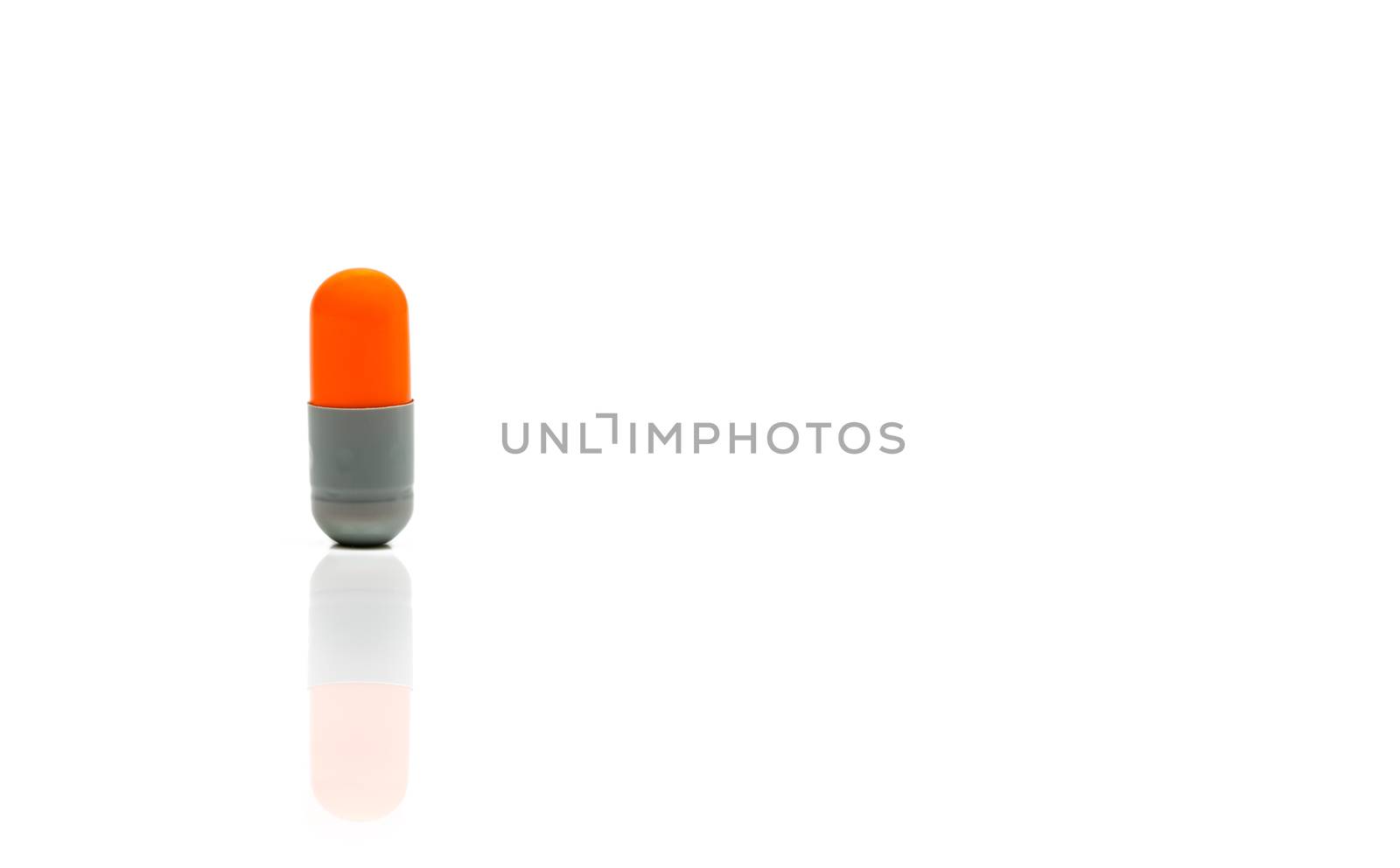 Orange, gray antibiotics capsule pill isolated on white background with copy space. Drug resistance concept. Antibiotics drug use with reasonable and global healthcare concept. by Fahroni