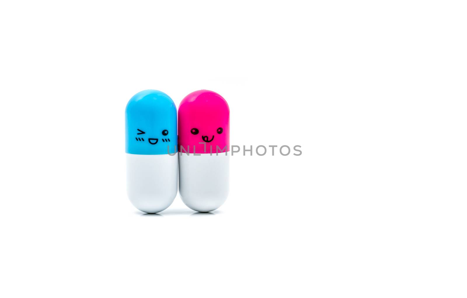 Cute blue and pink couple capsule pills isolated on white background with copy space for text. Global healthcare concept. Taking care of couple life. Pharmaceutical industry. Pharmacy sign and symbol. Pharmacy background. Health budgets and policy. by Fahroni