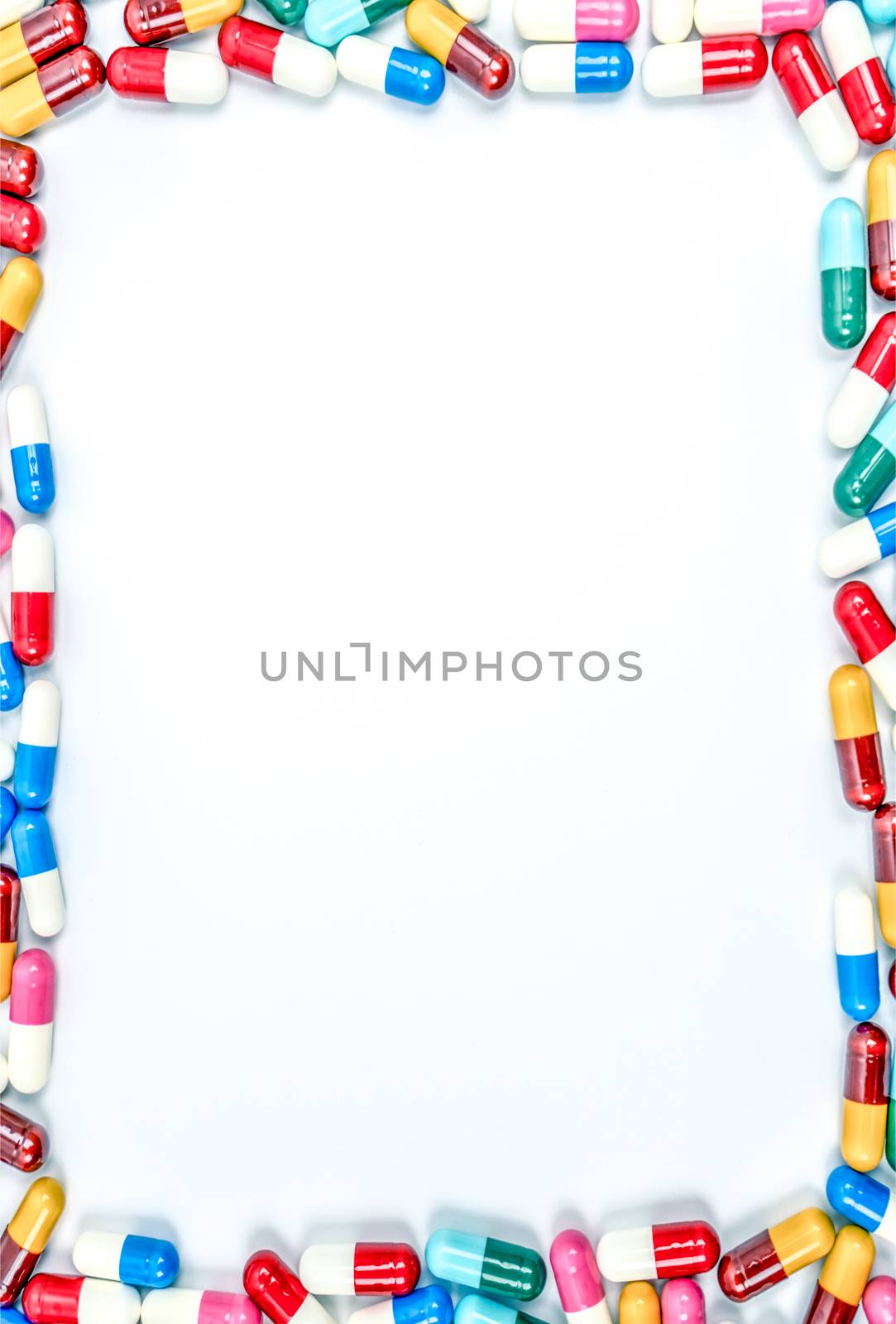 Colorful of antibiotics capsule pills on white background with copy space. Drug resistance concept. Antibiotics drug use with reasonable and global healthcare concept. Capsule frame. by Fahroni
