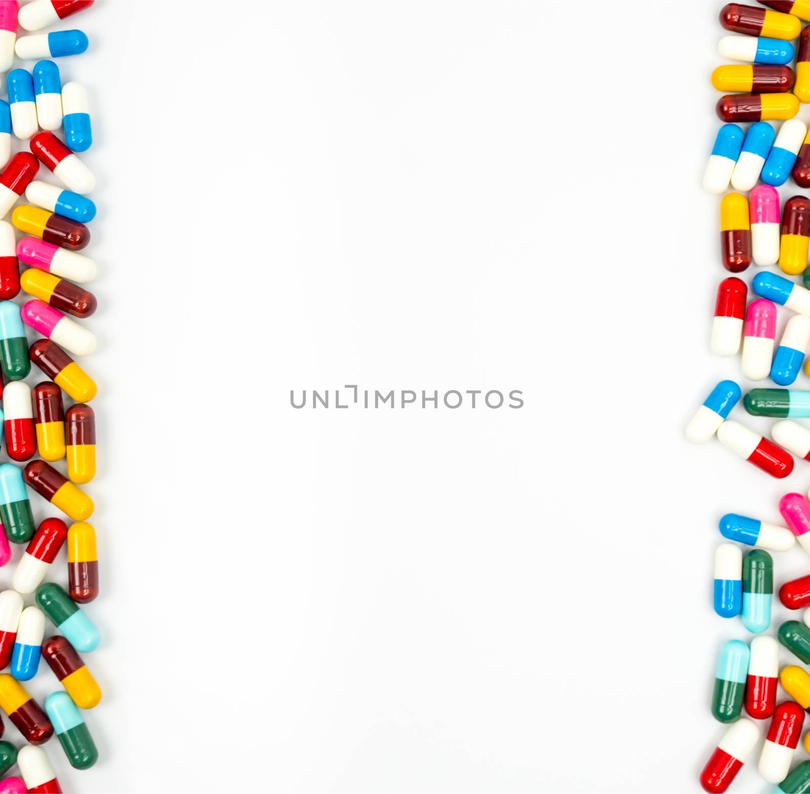 Colorful of antibiotic capsules pills isolated on white background with copy space. Drug resistance concept. Antibiotics drug use with reasonable and global healthcare concept. Capsule frame for education background. Pharmaceutical industry. Pharmacy background. by Fahroni