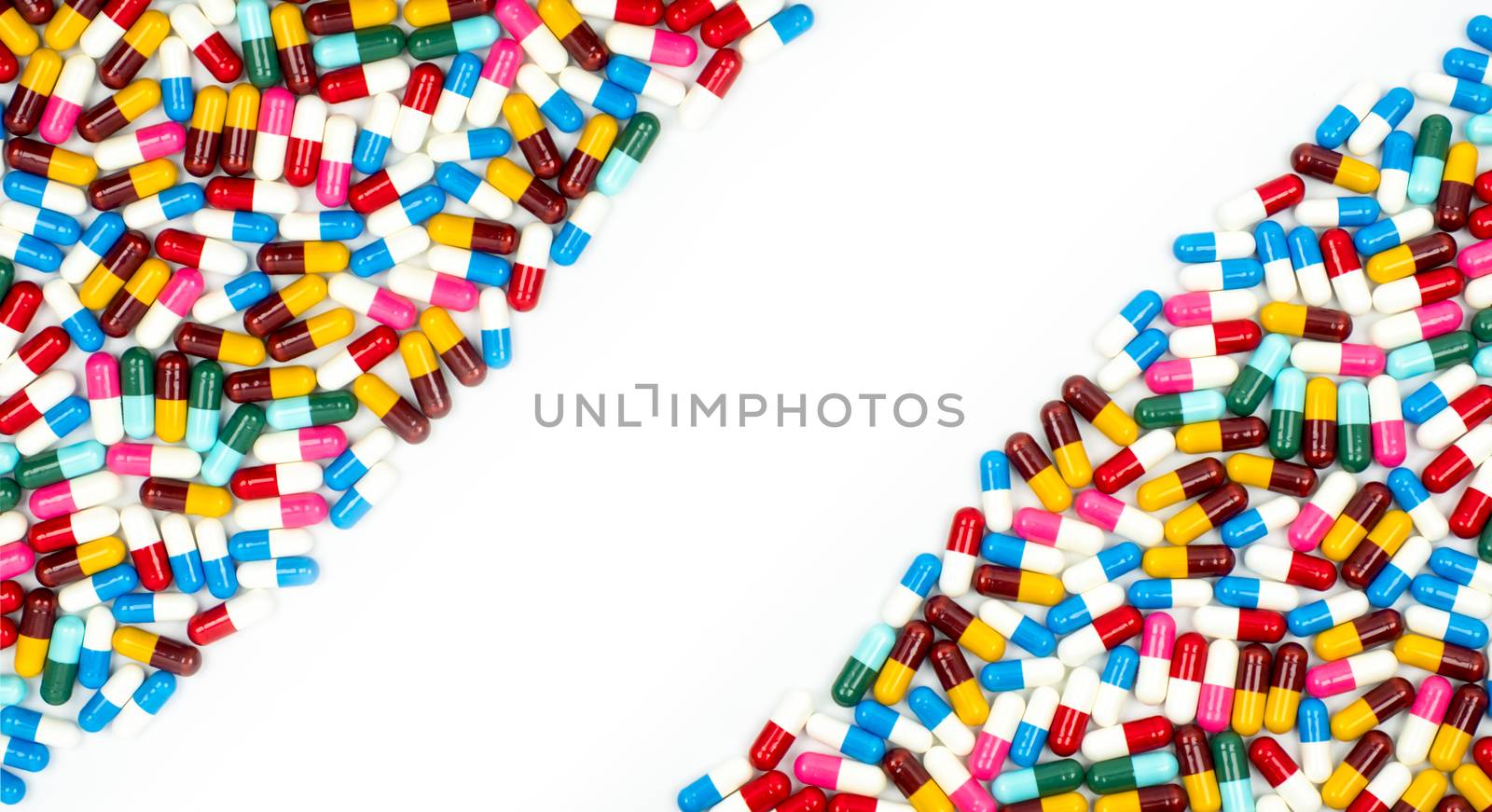 Colorful of antibiotic capsules pills on white background with beautiful pattern and copy space. Drug resistance concept. Antibiotics drug use with reasonable and global healthcare concept. Pharmacy background. by Fahroni