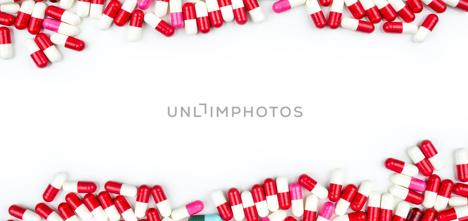 Colorful of antibiotic capsules pills isolated on white background with copy space for text. Drug resistance concept. Antibiotics drug use with reasonable and global healthcare concept. Pharmaceutical industry. Pharmacy background. by Fahroni