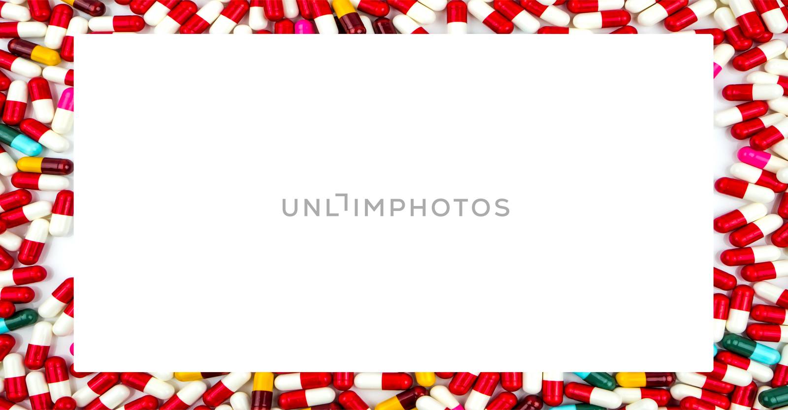 Colorful of antibiotics capsule pills rectangle frame on white background with copy space. Drug resistance concept. Antibiotics drug use with reasonable and global healthcare concept.