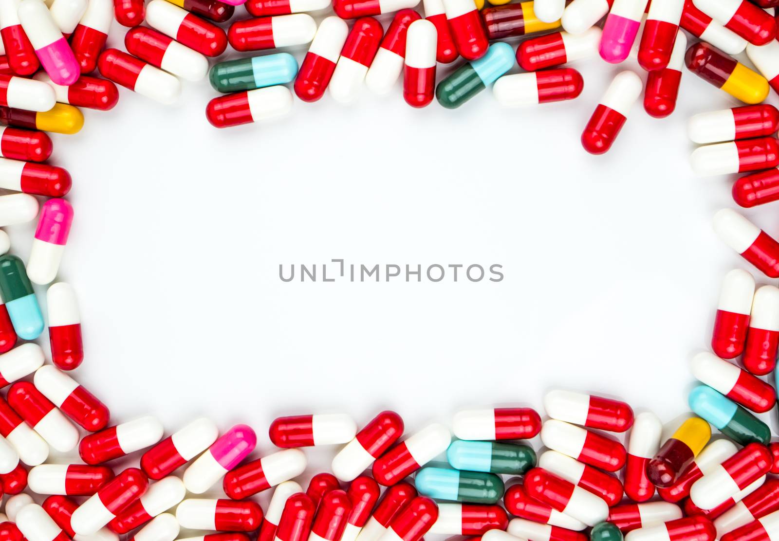 Colorful of antibiotics capsule pills rectangle frame on white background with copy space. Drug resistance concept. Antibiotics drug use with reasonable and global healthcare concept. Pharmaceutical industry. Pharmacy background.