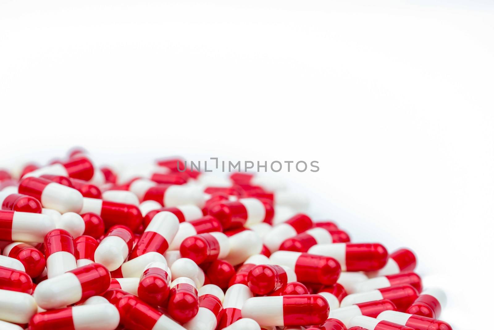 Selective focus of antibiotic capsules pills on white background with copy space. Drug resistance concept. Antibiotics drug use with reasonable and global healthcare concept. Pharmaceutical industry. Pharmacy background. Health budgets and policy.