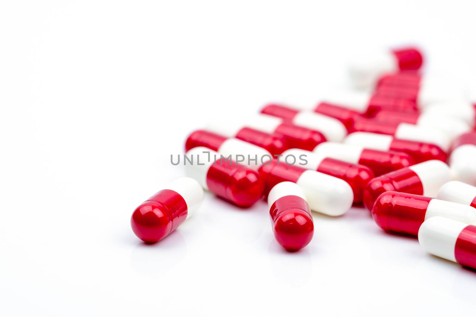 Selective focus of antibiotic capsules pills on white background with copy space. Antimicrobial drug resistance concept. Antibiotics drug use with reasonable and global healthcare concept. Pharmaceutical industry. Pharmacy background.