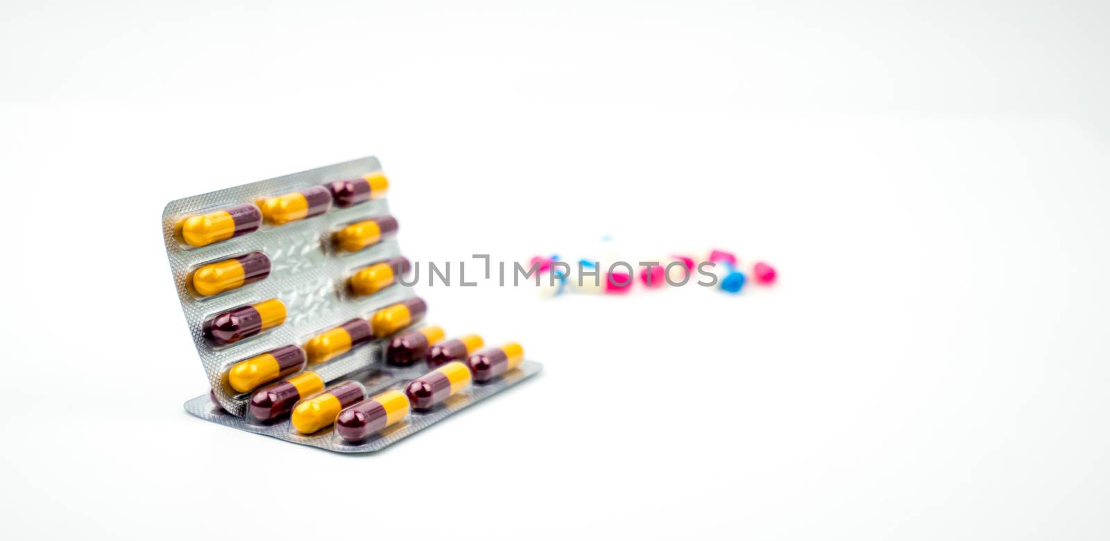 Colorful of antibiotic capsules pills on blurred background with copy space. Drug resistance, antibiotic drug use with reasonable, health policy and health insurance concept. Pharmaceutical industry. Pharmacy background. by Fahroni
