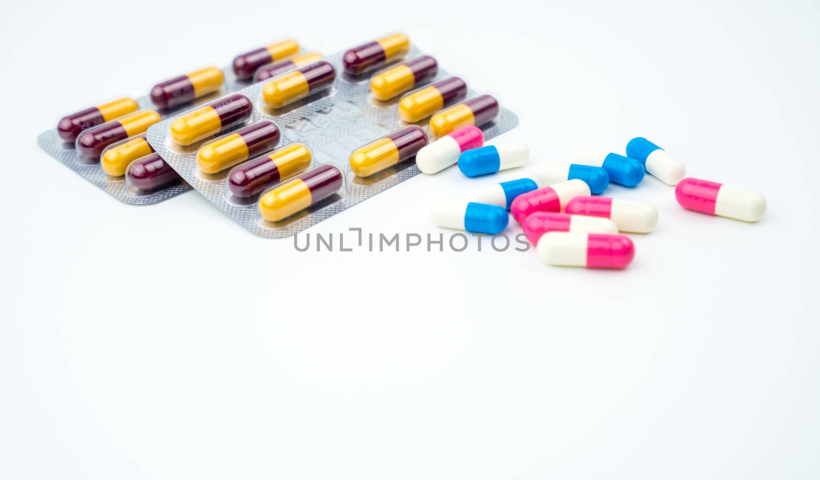 Colorful of antibiotic capsules pills on white background with copy space. Drug resistance, antibiotic drug use with reasonable, health policy and health insurance concept. Pharmaceutical industry. Pharmacy background.