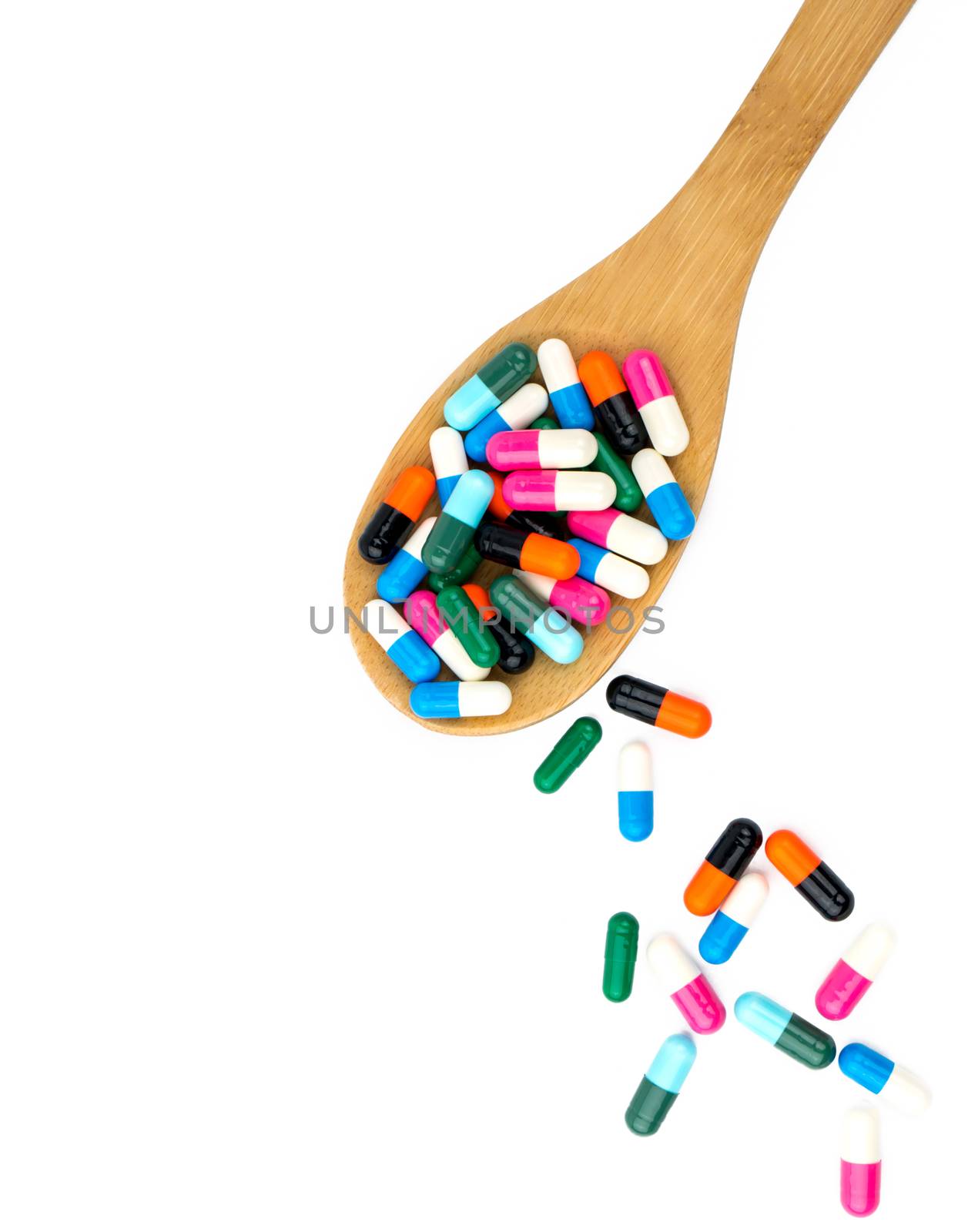 Colorful of antibiotics capsule pills in wooden spoon are spilling isolated on white background with copy space and clipping path. Antibiotic drug use with reasonable and health insurance concept. by Fahroni