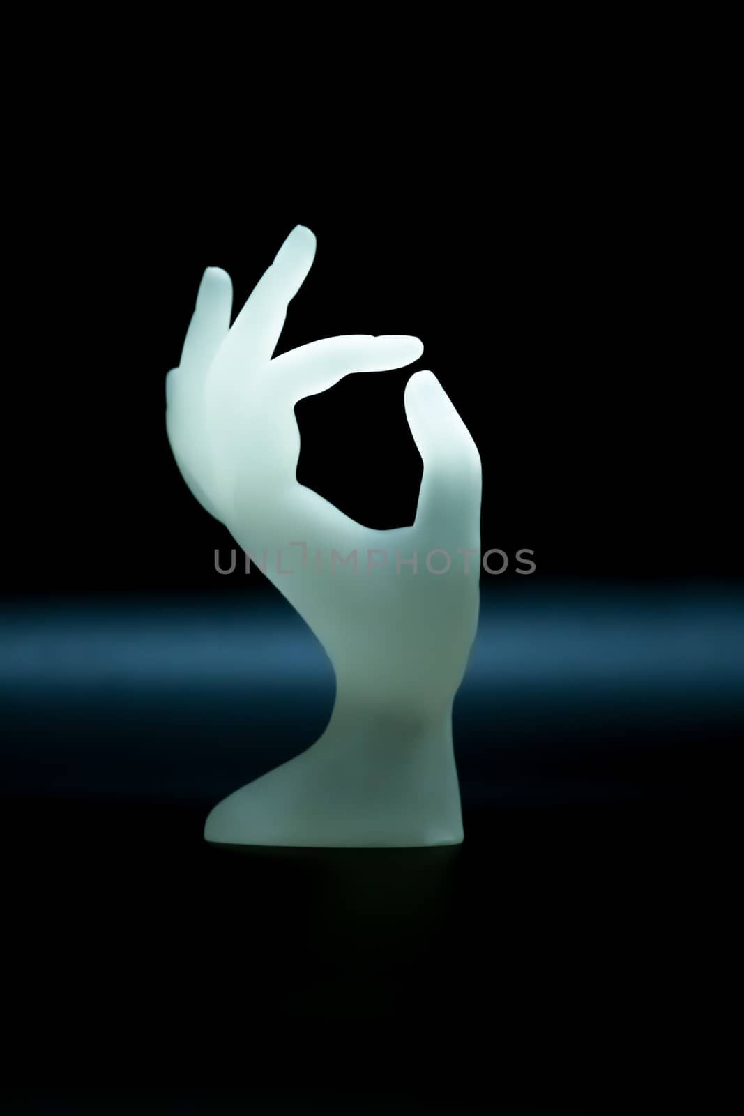 OK hand shape resin ring display holder for jewelry display on dark background use for advertising design for jewelry shop or nail salon with copy space by Fahroni