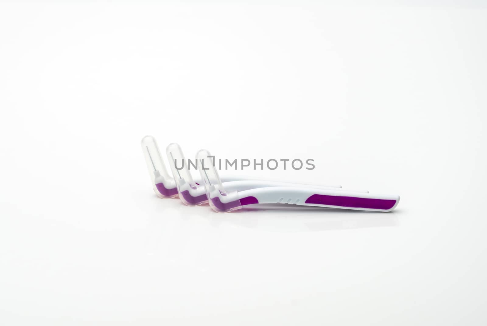 Three interdental brush with cover isolated on white background with copy space, just add your own text