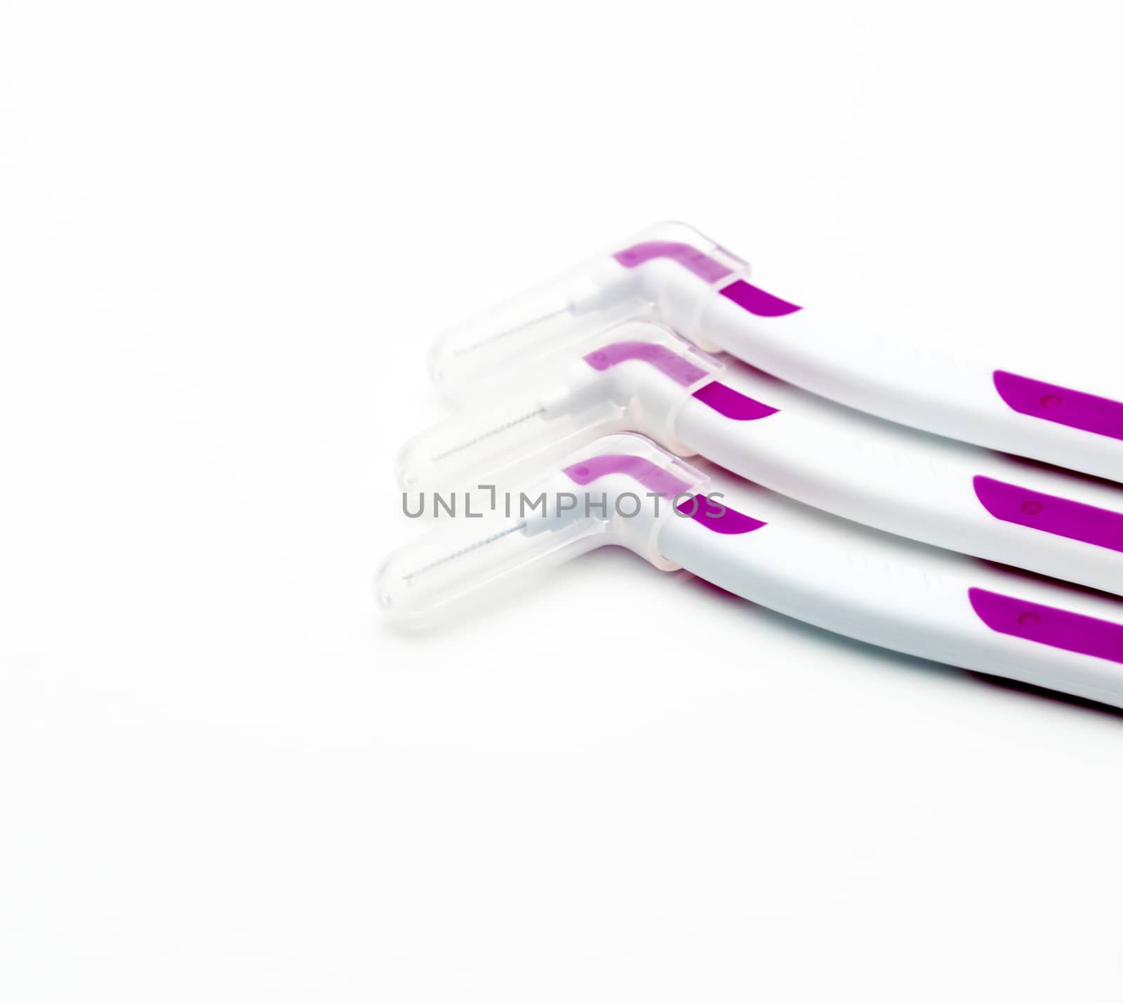 Three interdental brush with cover isolated on white background with copy space.