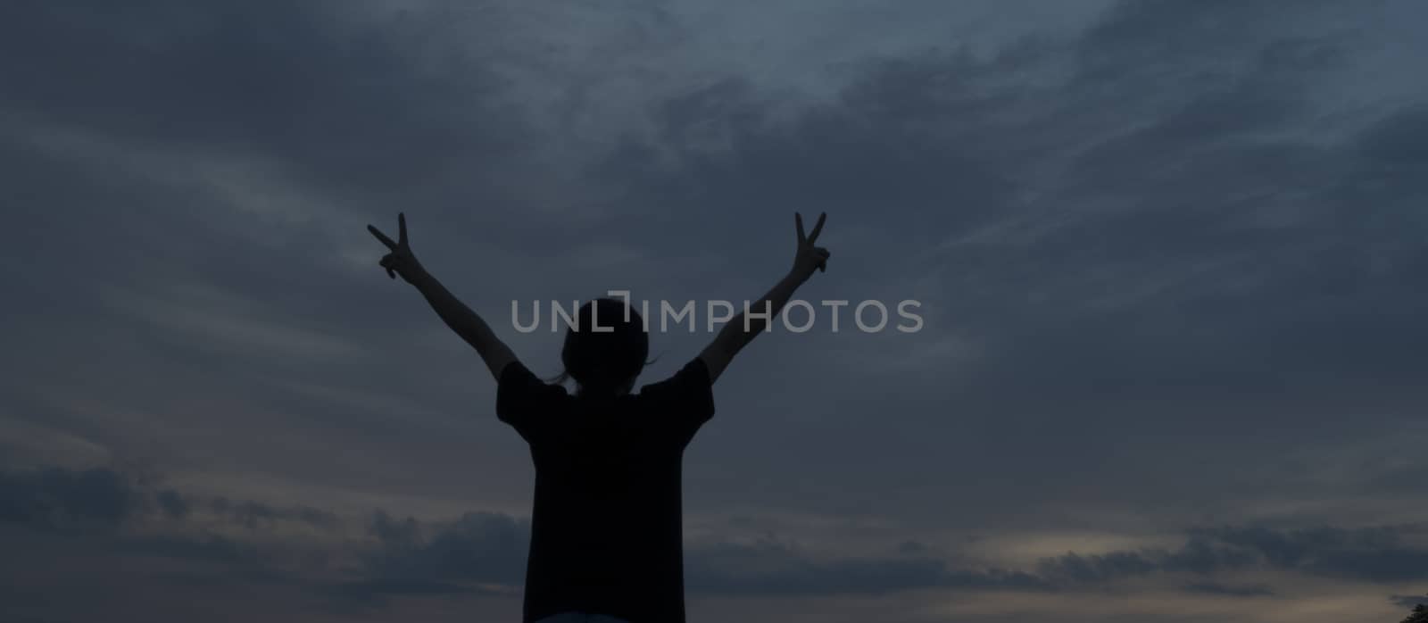 The silhouette of a woman with open hands