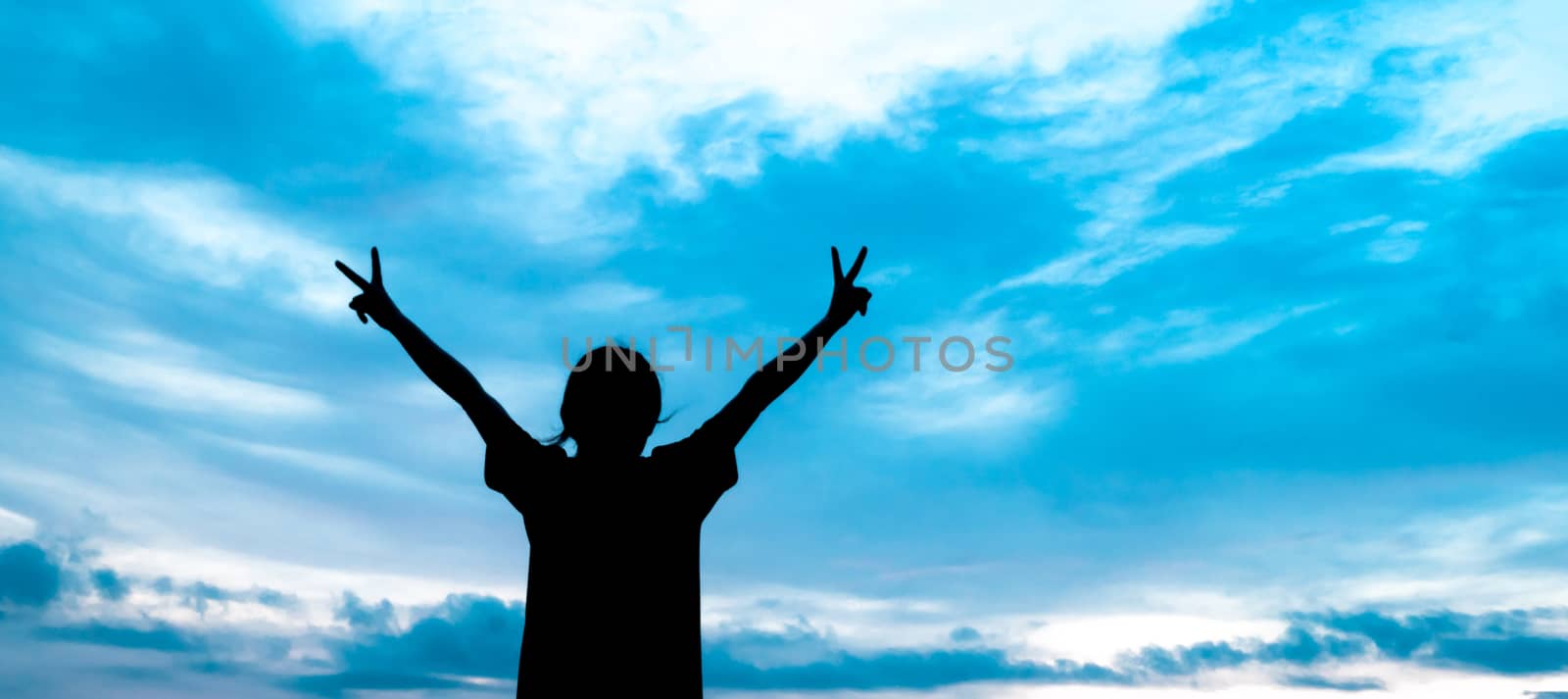 The silhouette of a woman with open hands