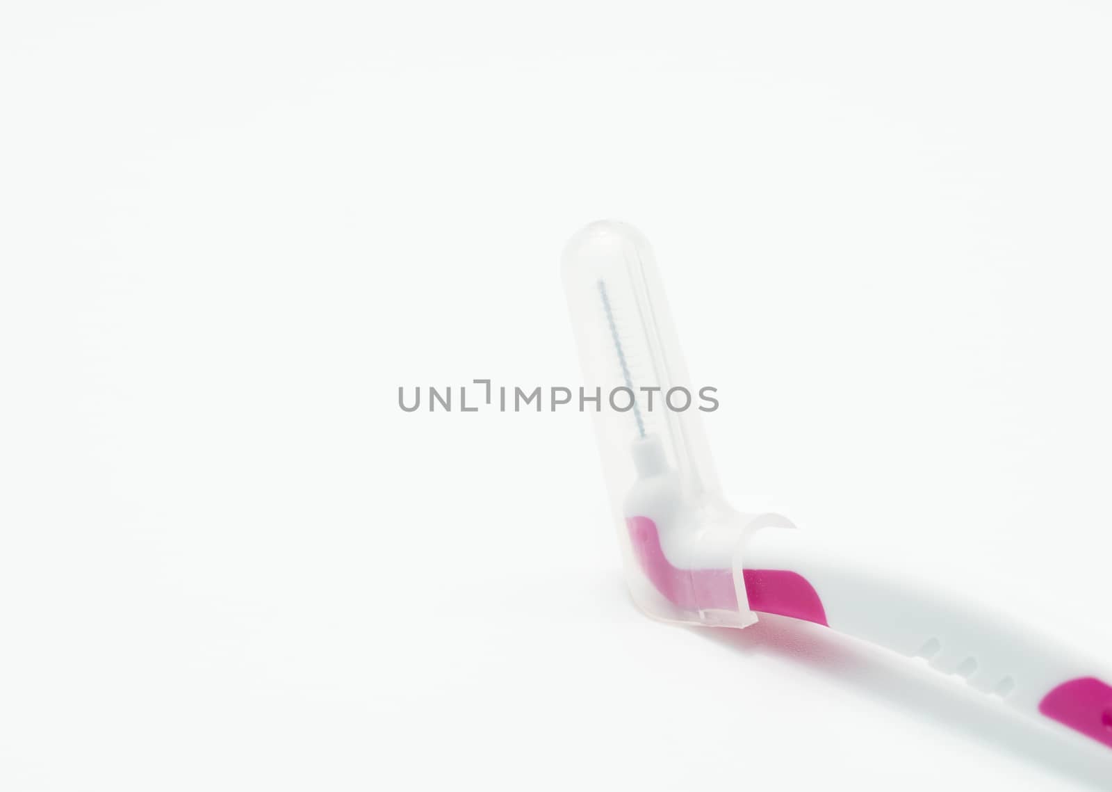 Interdental brush with cover isolated on white background by Fahroni