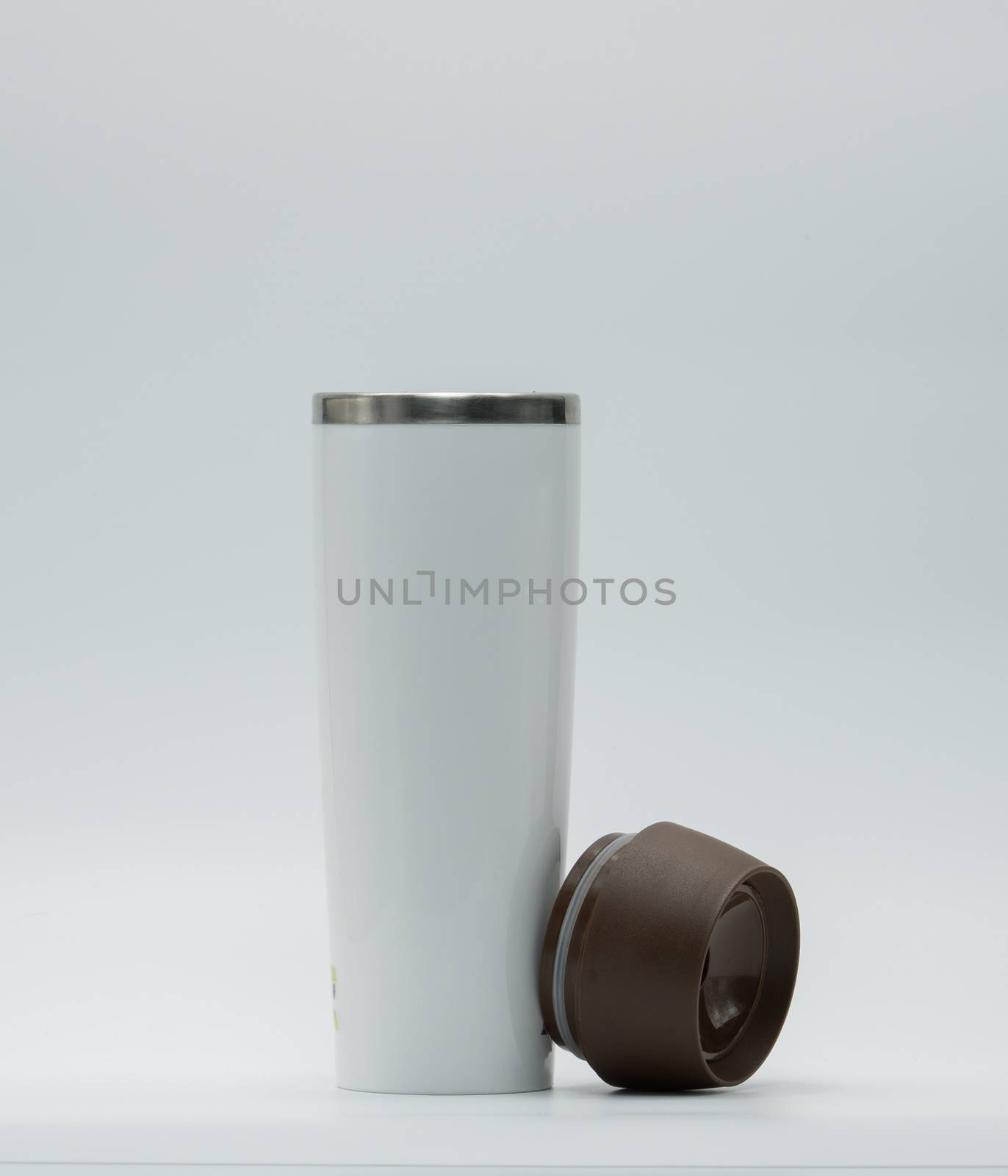 Modern thermos bottle with opened lid isolated on white background