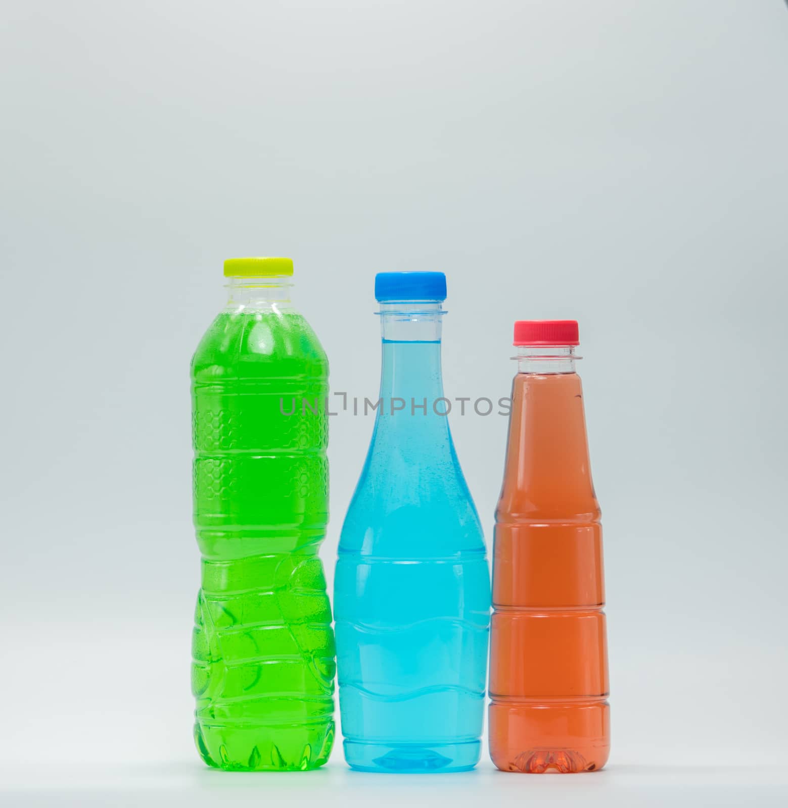 Three modern design bottles of soft drink on white background