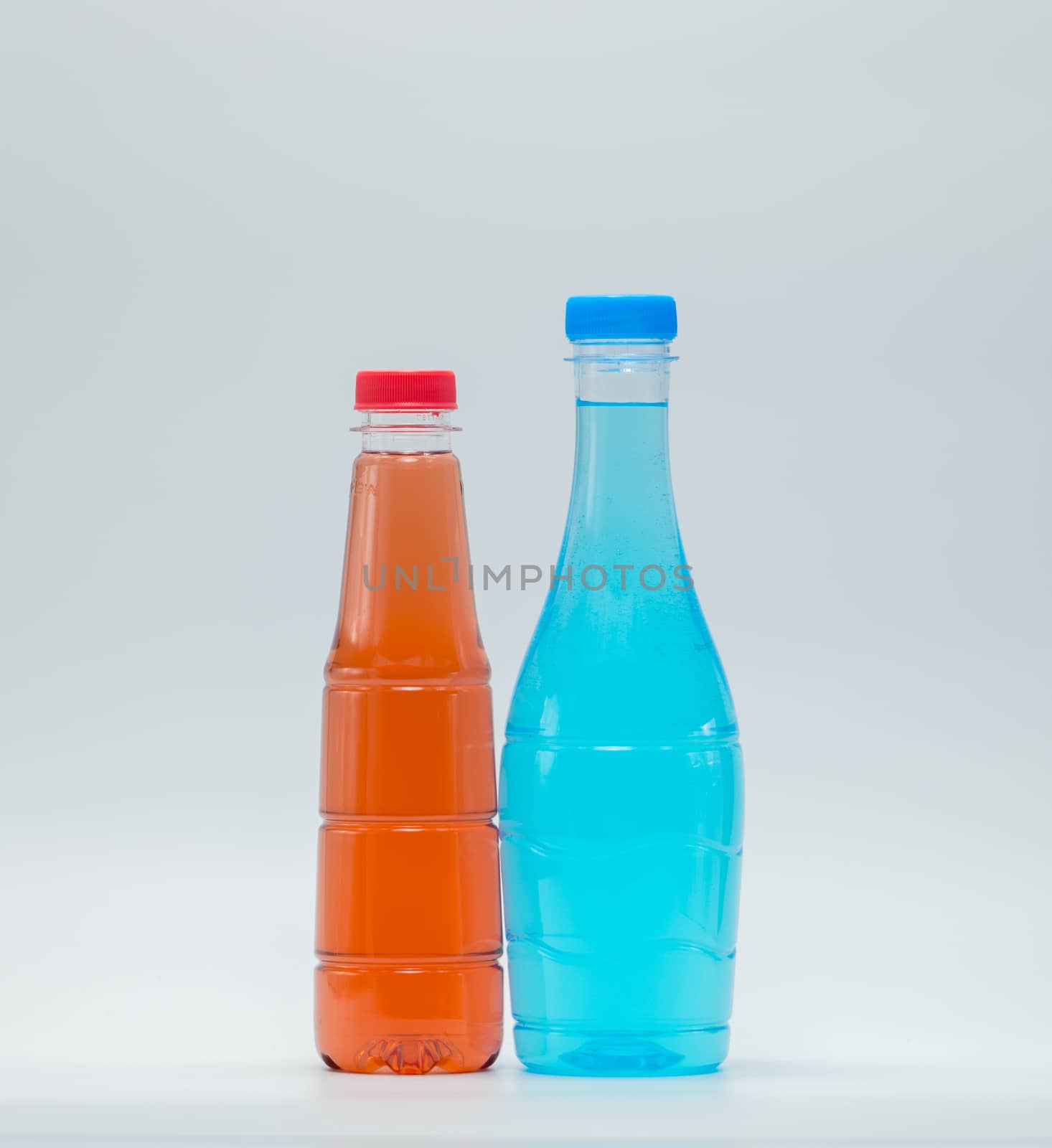 Two modern design bottles of soft drink on white background