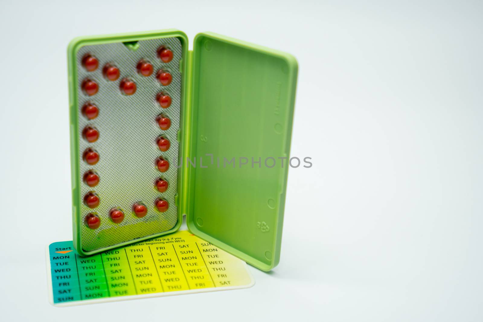 Contraceptive pills with modern package on white background. Birth control pill. Pharmaceutical product. Pharmacy background. Family planning. by Fahroni